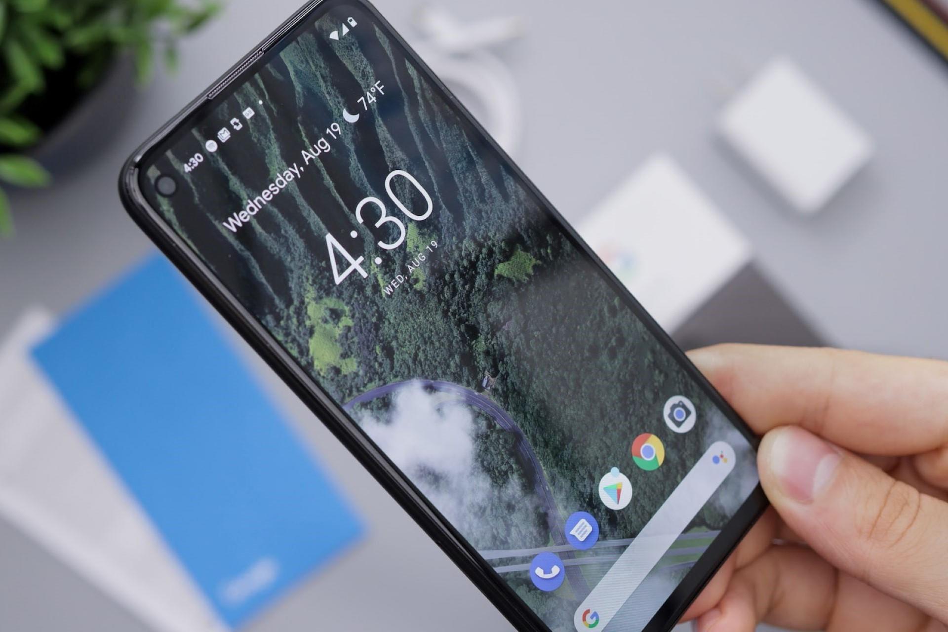 A hand holding a smartphone.