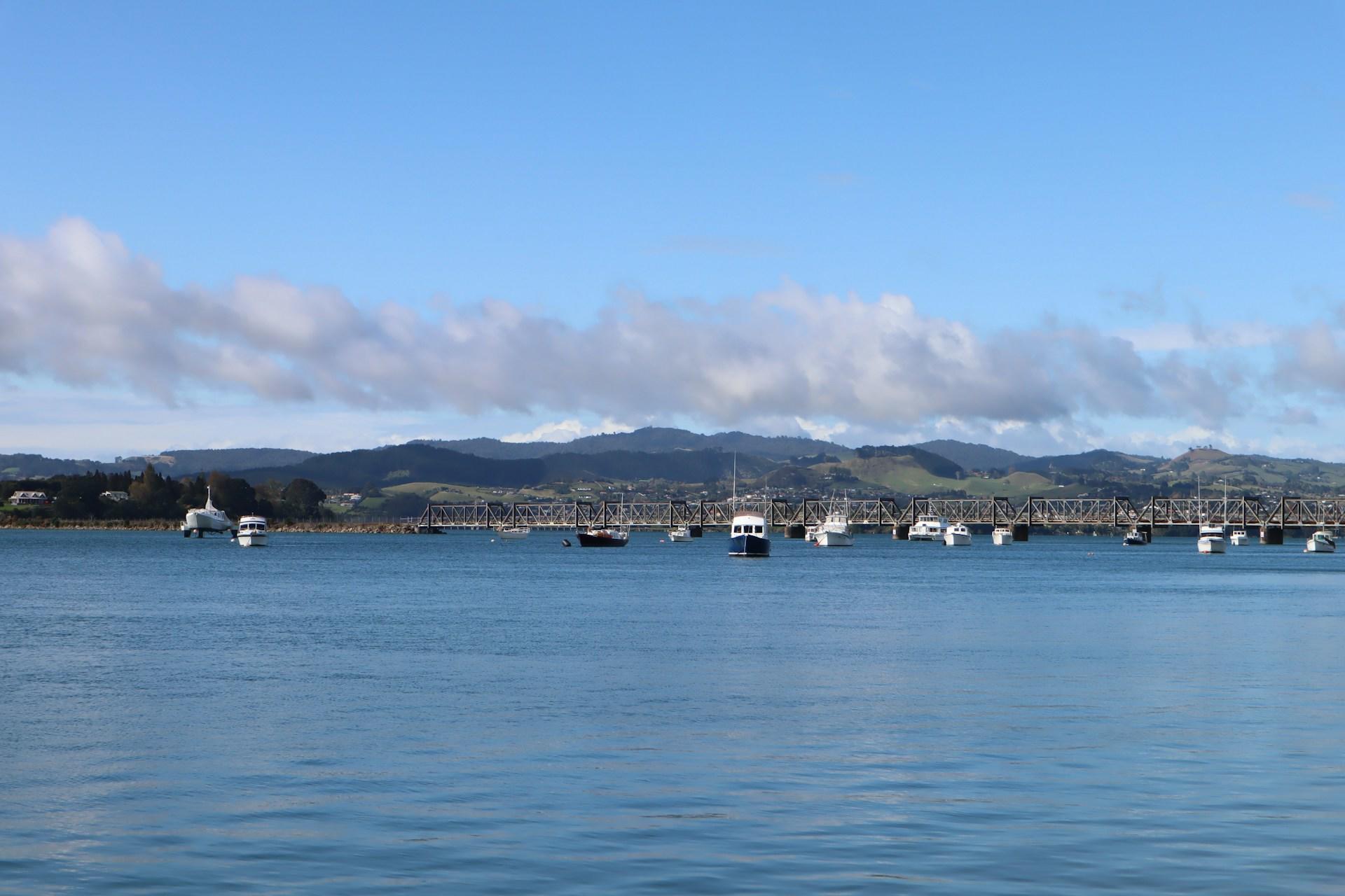 A view of a train bridge across the water in Tauranga, New Zealand.