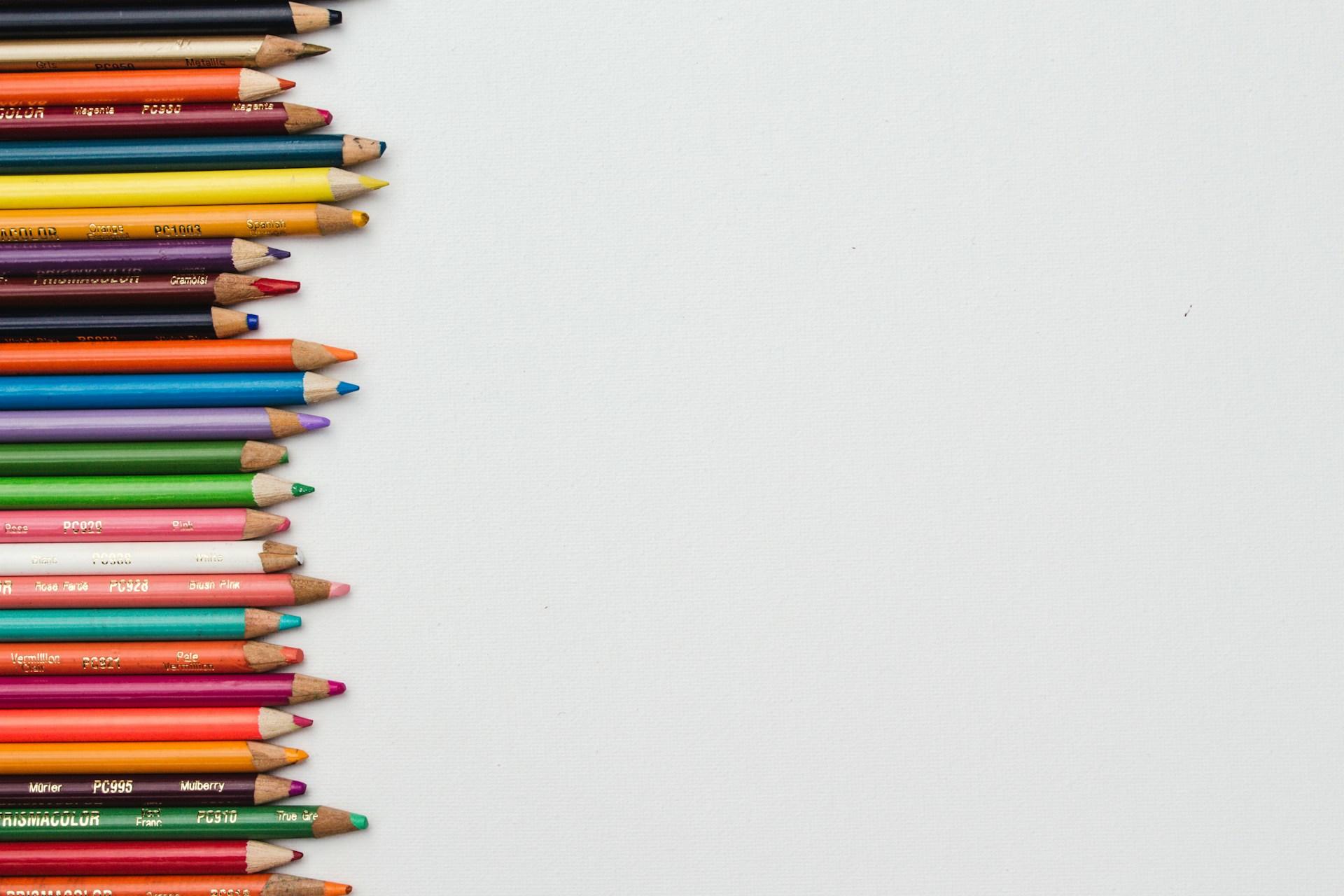 Coloured pencils lying on a white piece of paper.