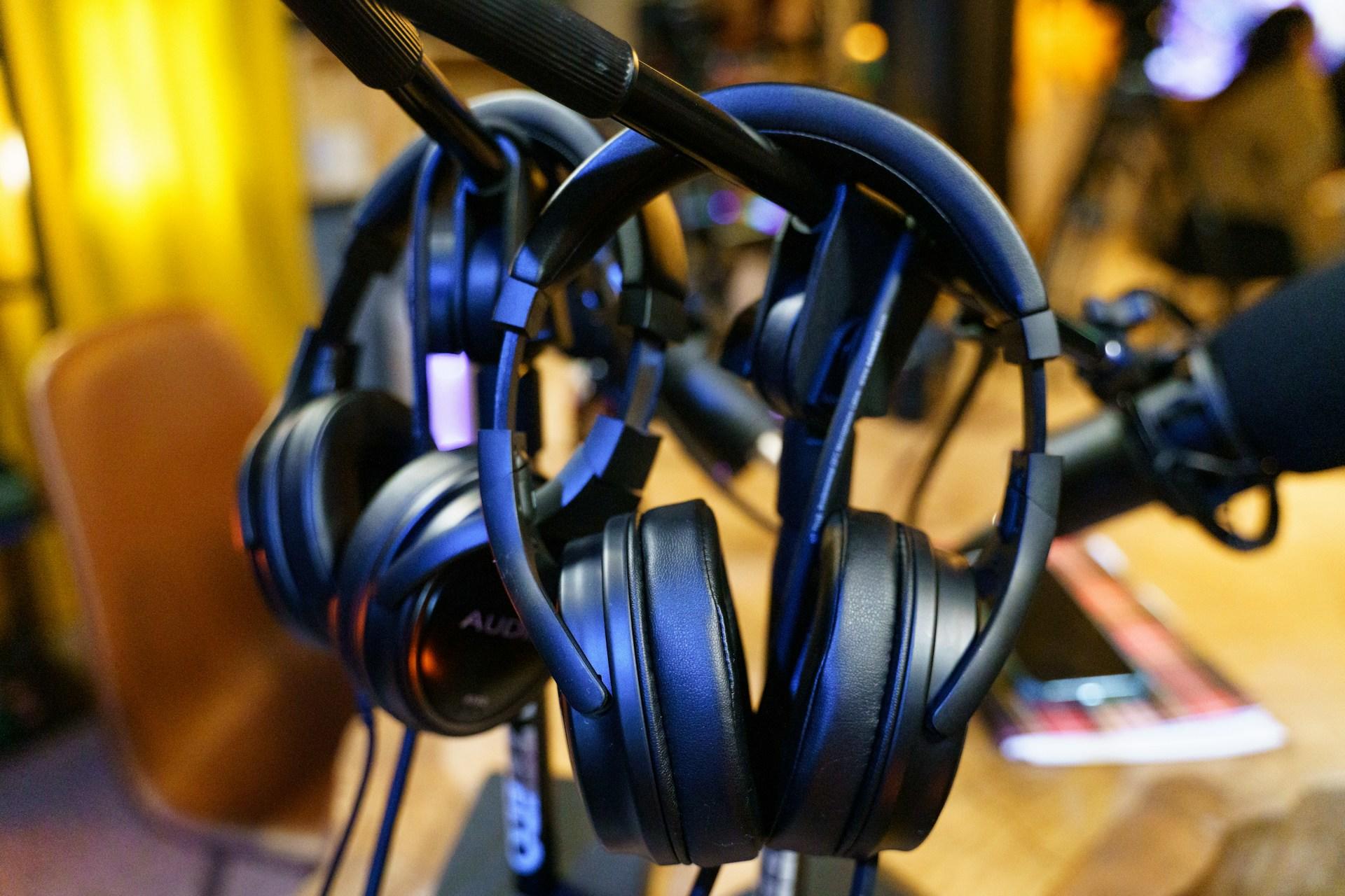 Headphones hanging up in a studio.