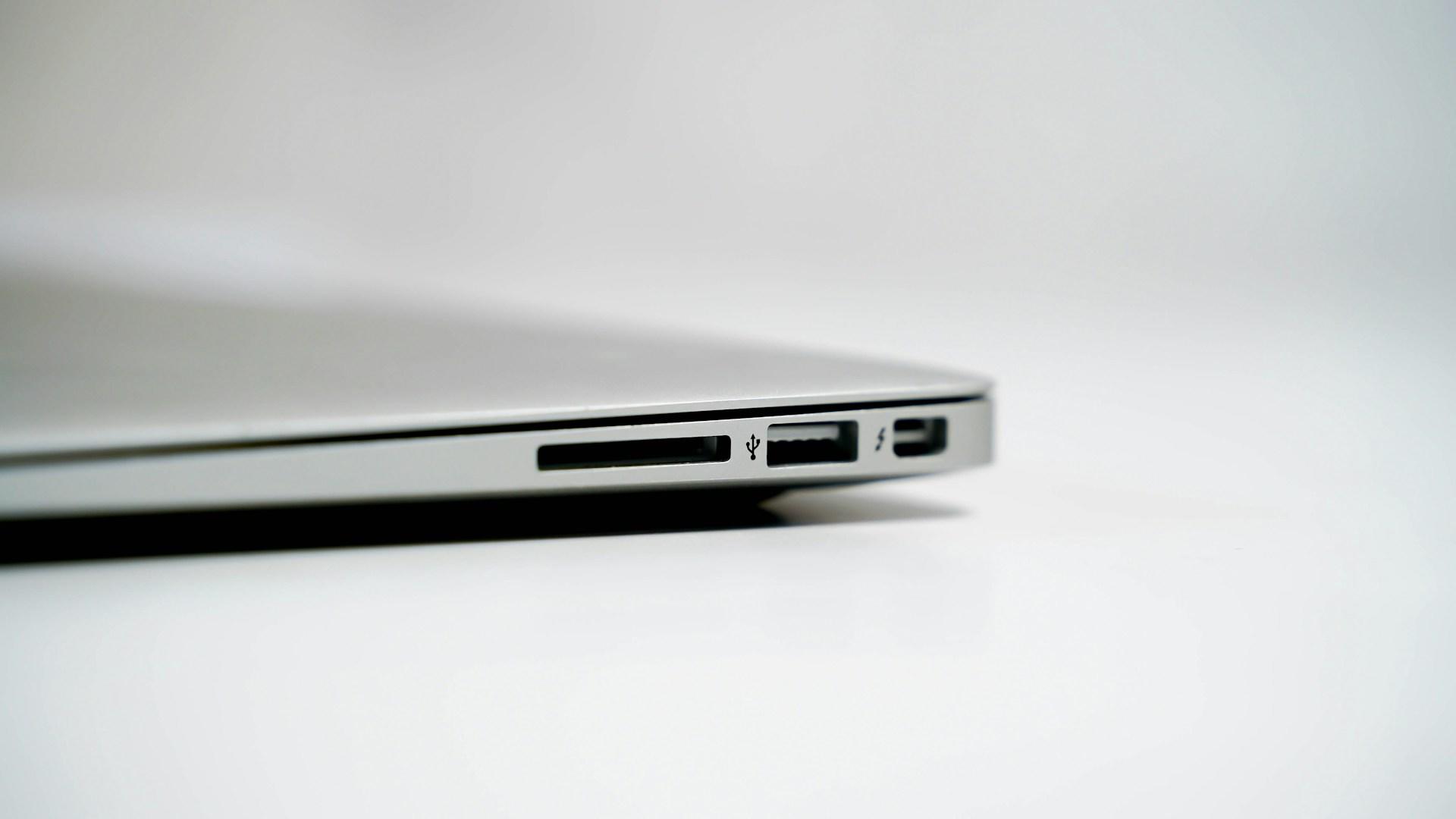 A closeup of the side of a MacBook and its ports.