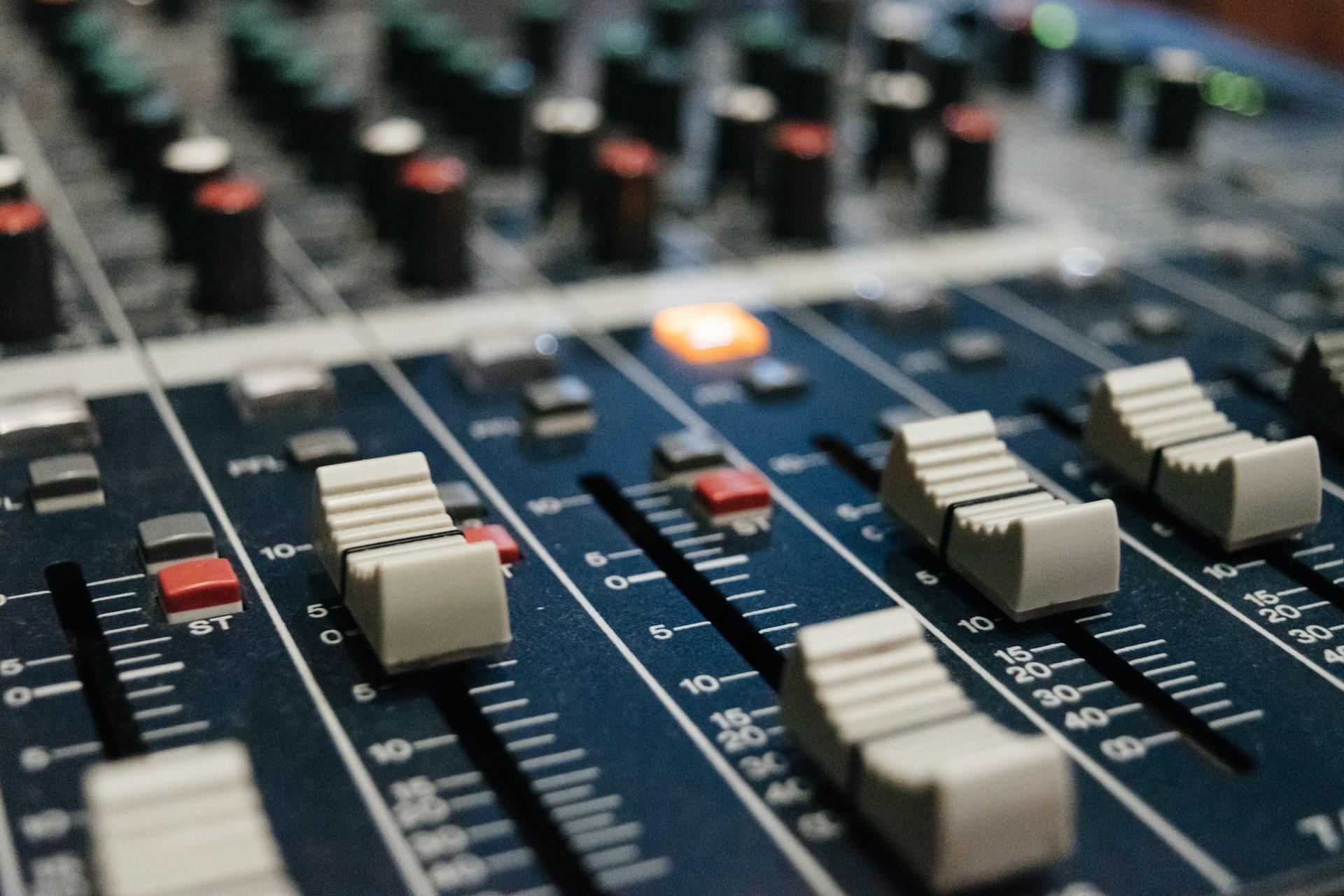 A closeup of an audio mixing desk.