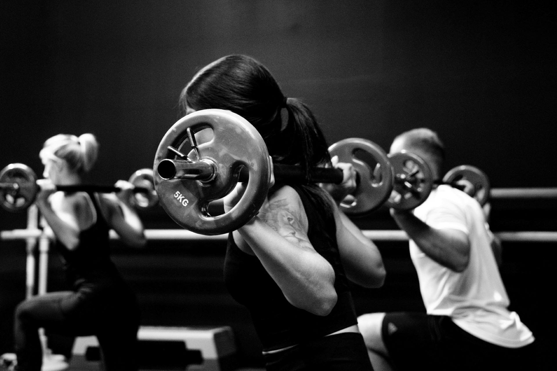 People lifting weights in a training session.