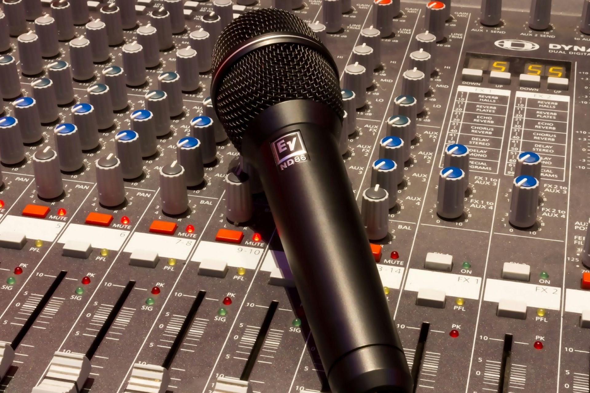 A microphone on a mixing desk.