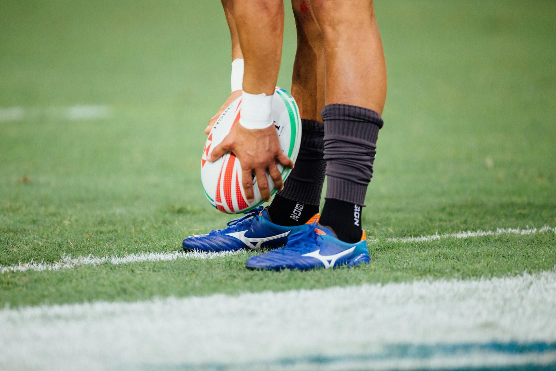 A rugby player holding a ball.