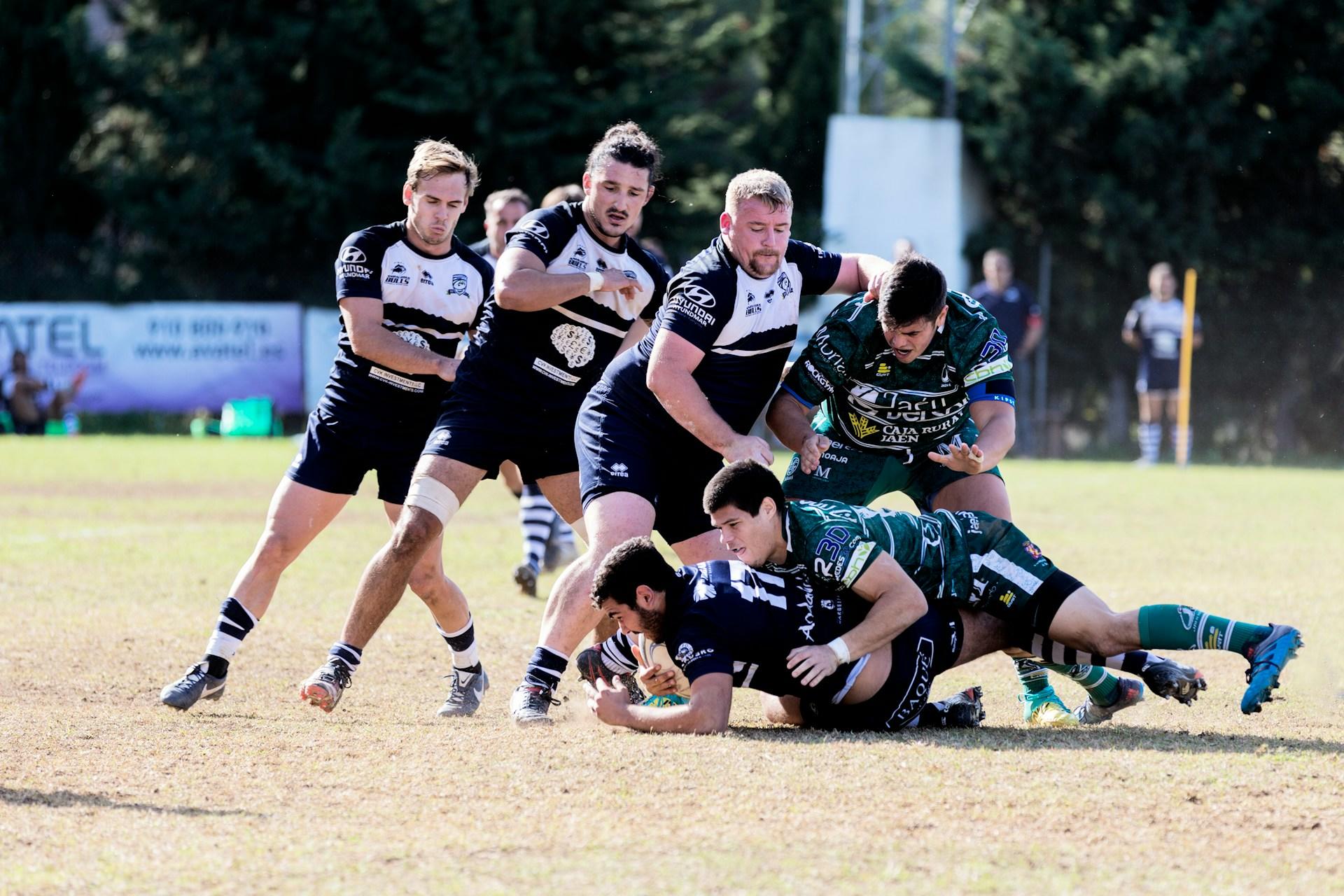 A rugby player making a tackle.