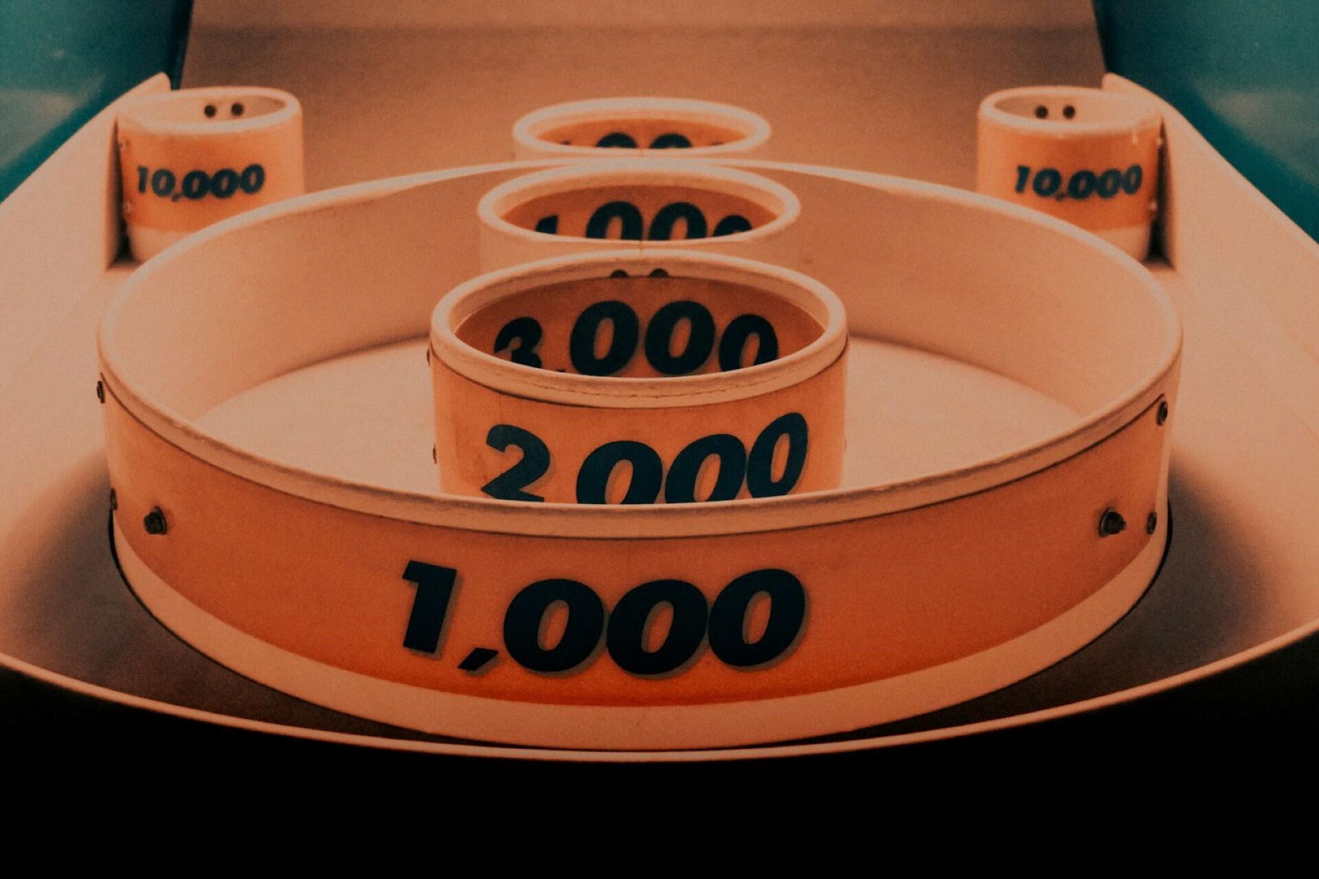 Wooden numbered rings arranged concentrically, showing different numerical values.