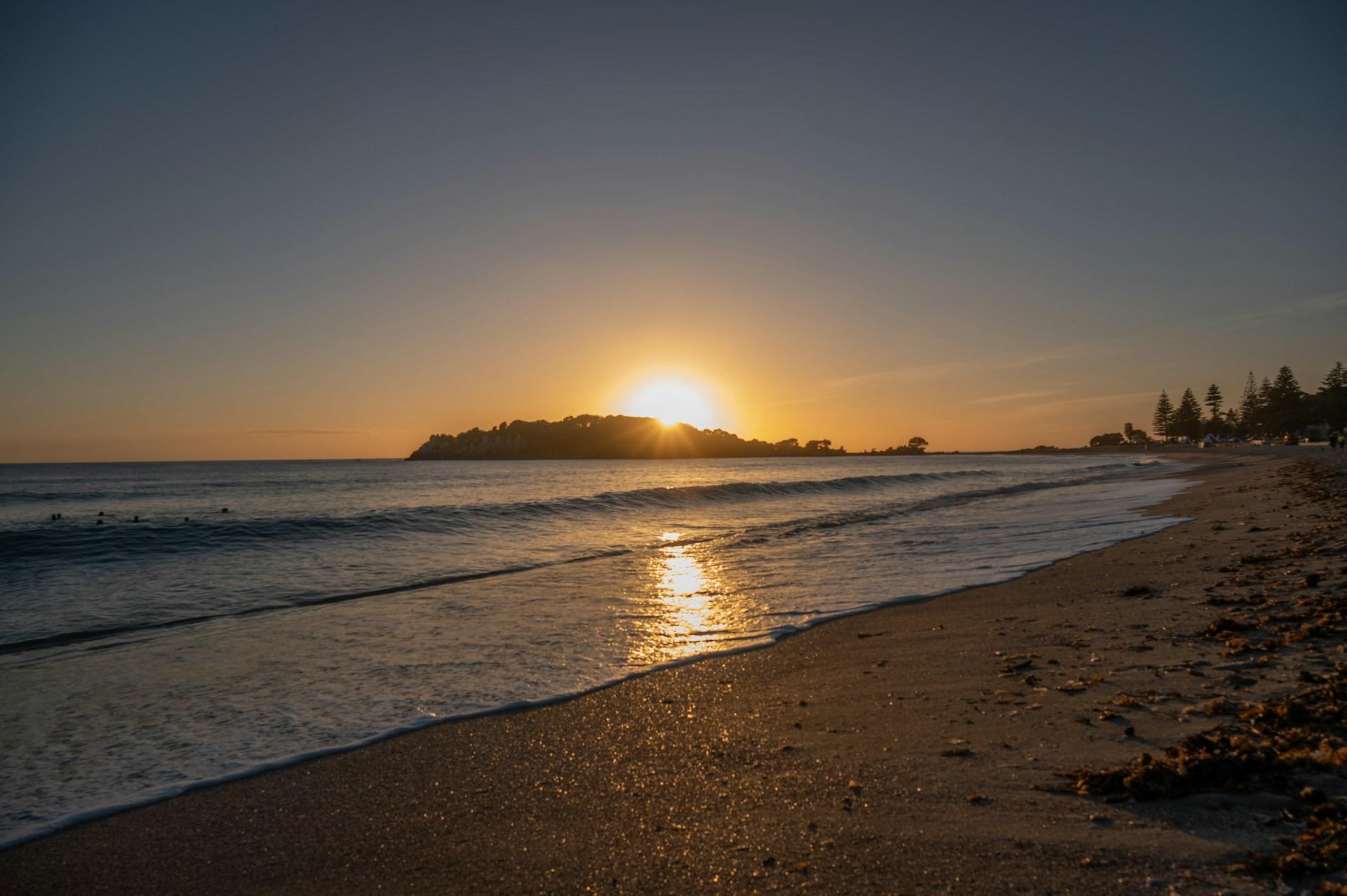 A beach in New Zealand at sunset.