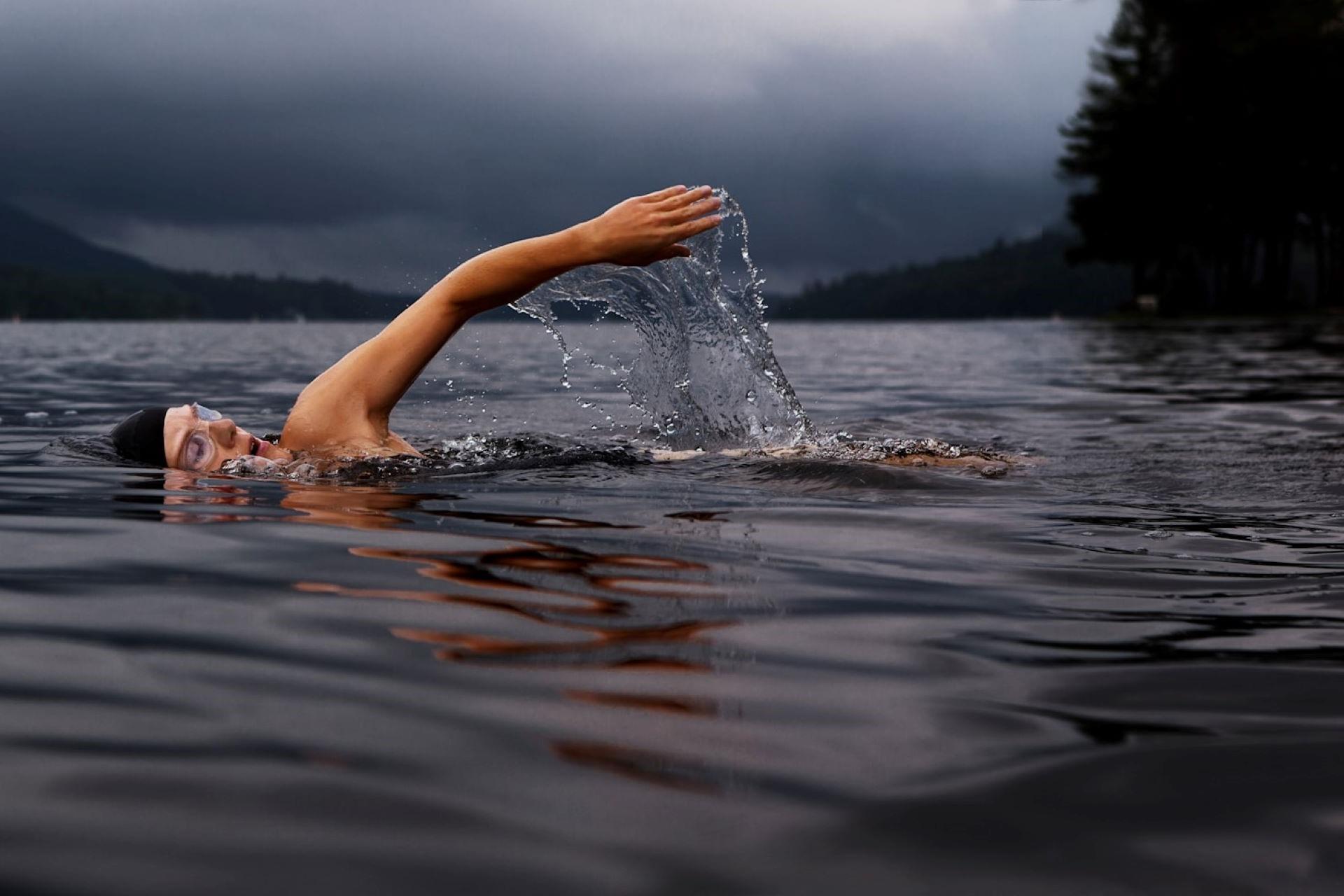 A person swimming outdoors.