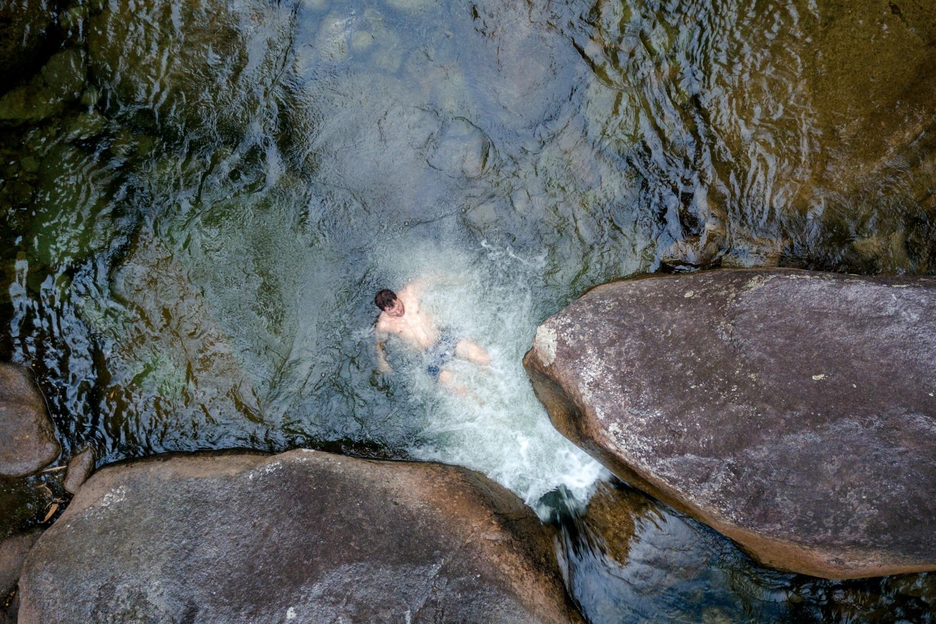 A person swimming outdoors.