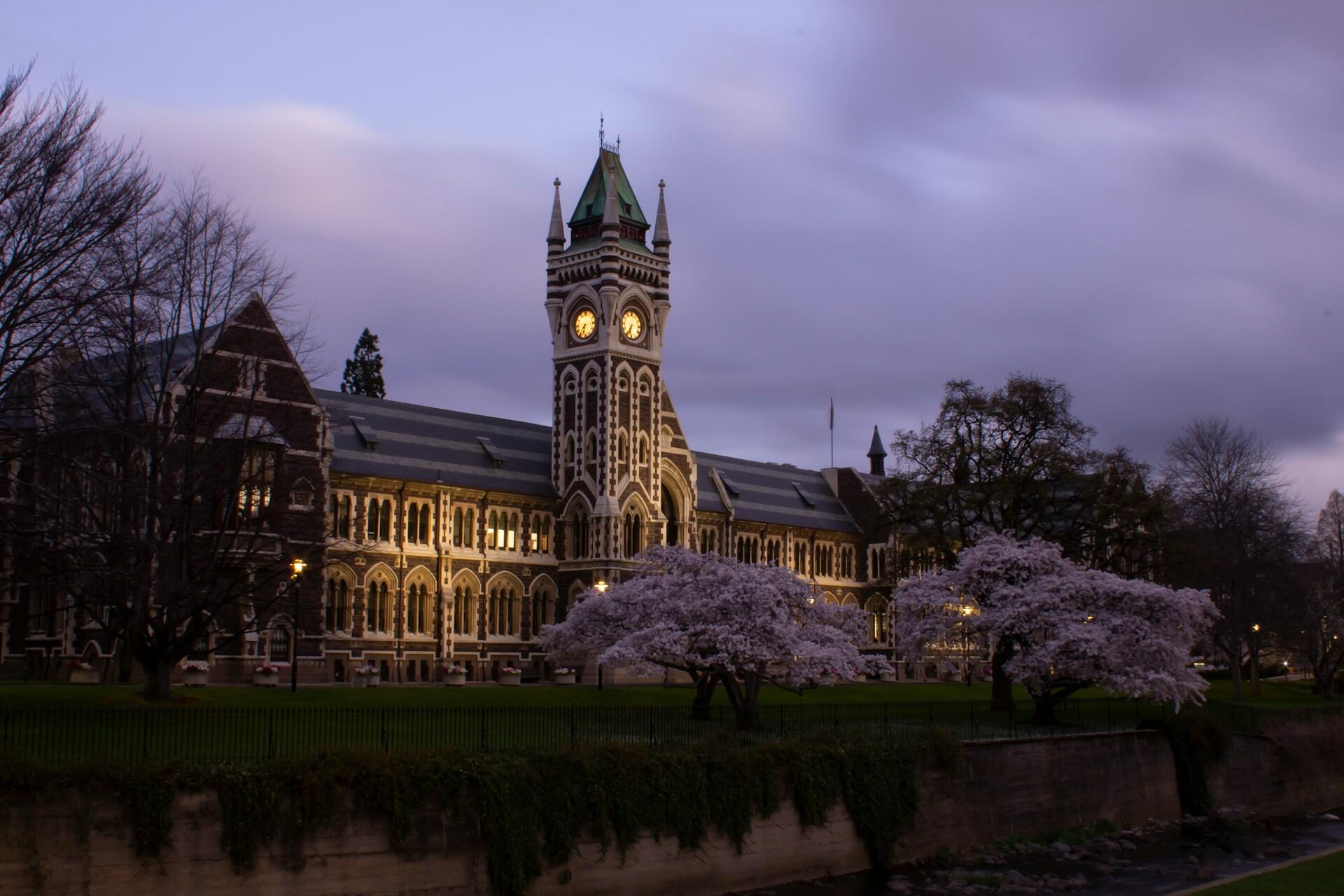 University of Otago campus building with clock tower at dusk