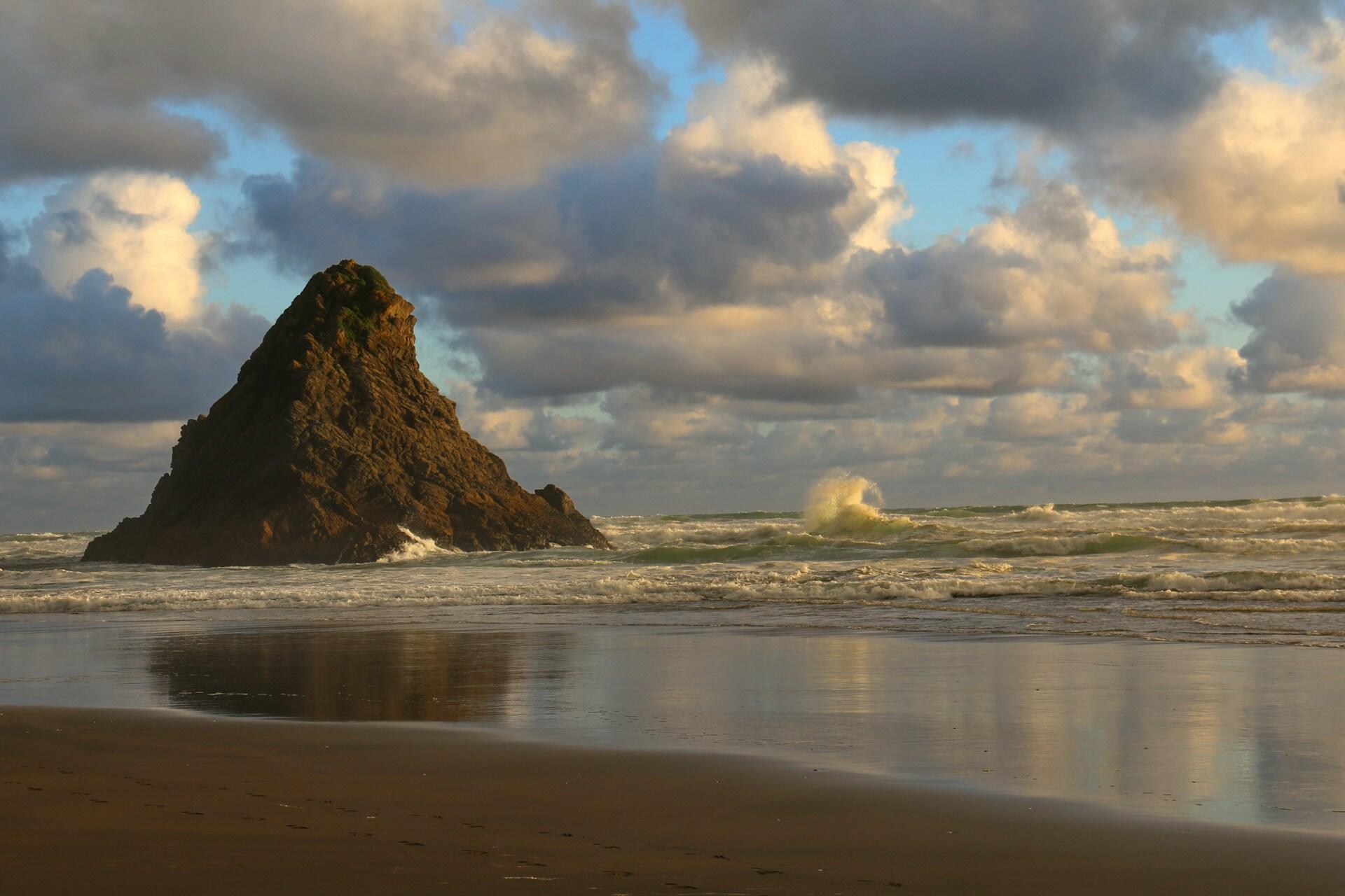 A rock formation in the sea by the Karekare coast.