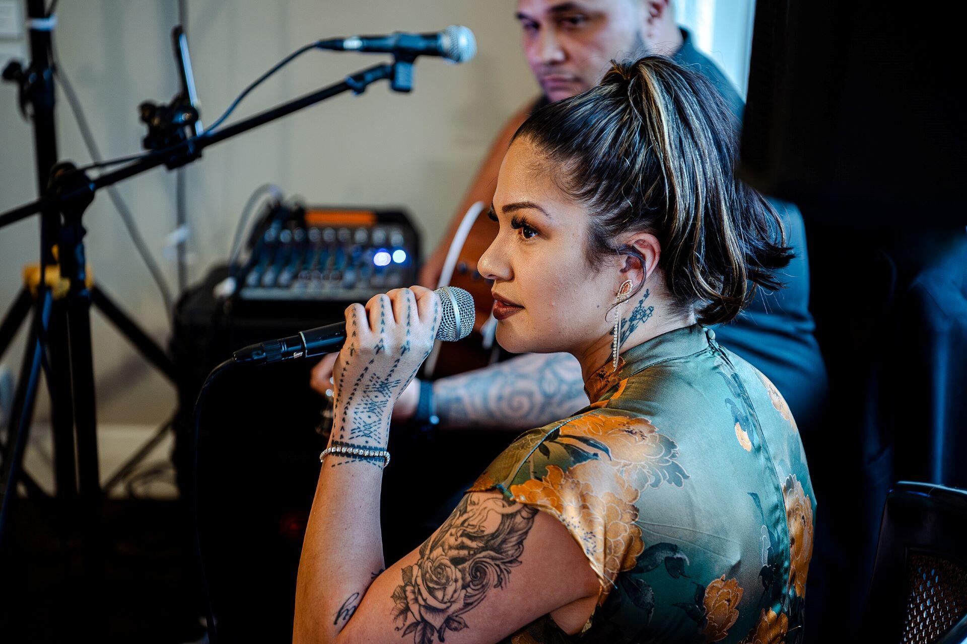 A Maori woman singing.