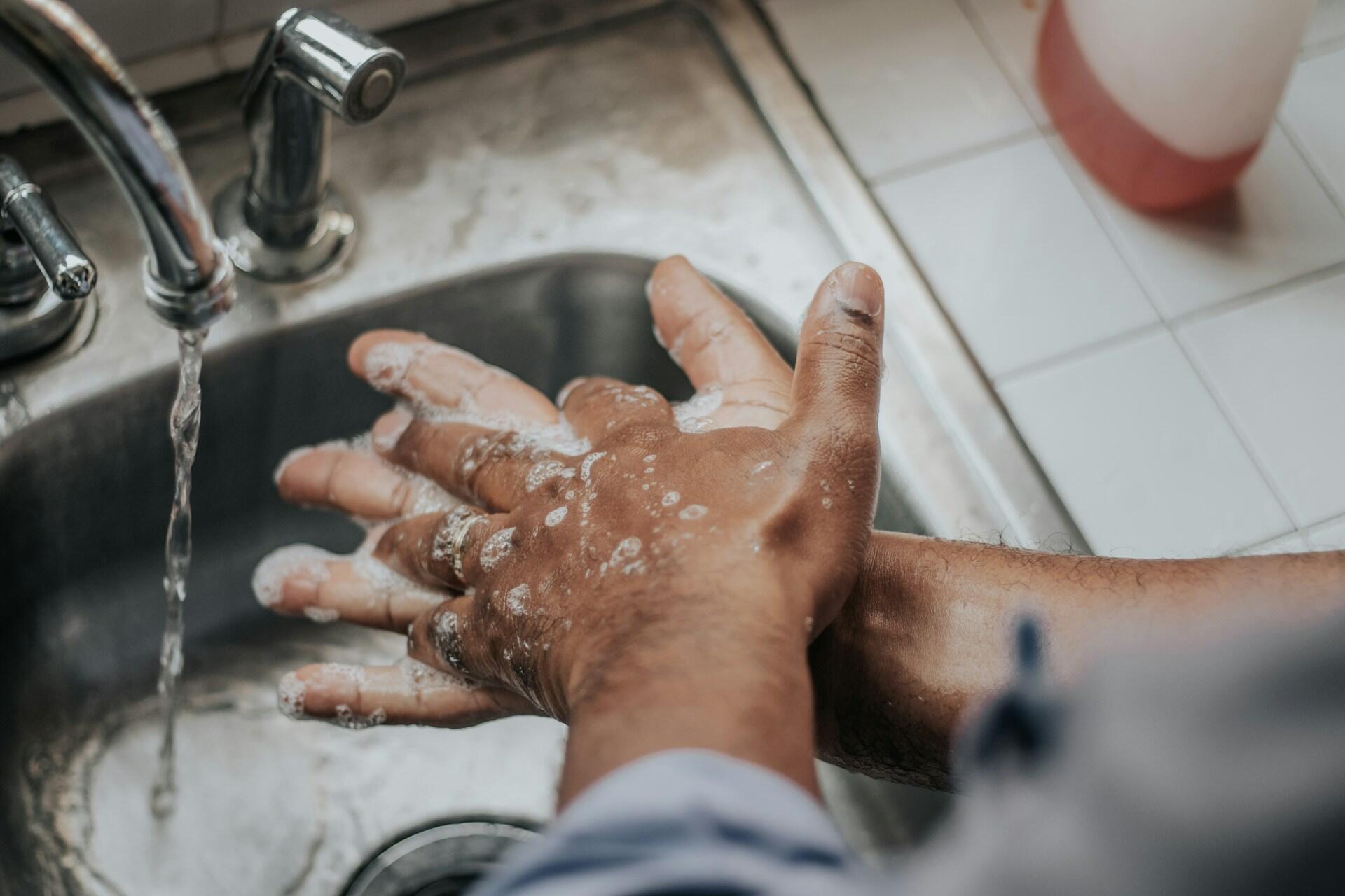 A person washing their hands.