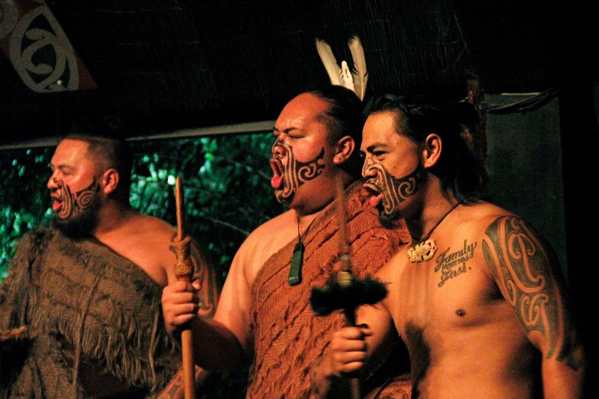 Maori people performing a dance together.