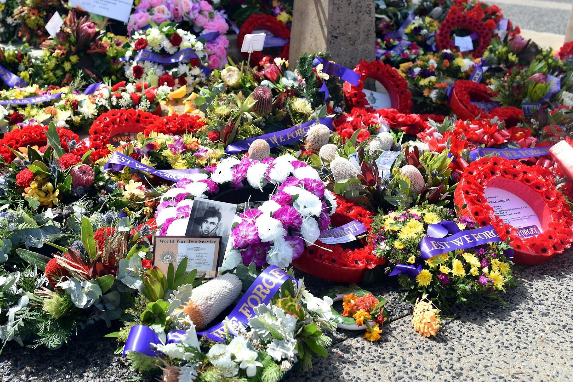 Wreaths at the base of an Anzac memorial.