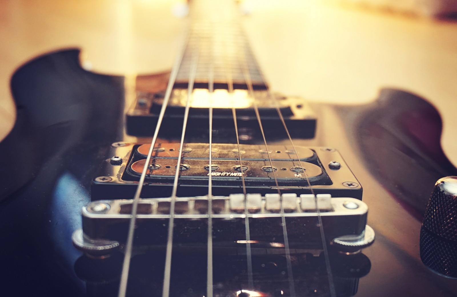 the strings across the body of the guitar