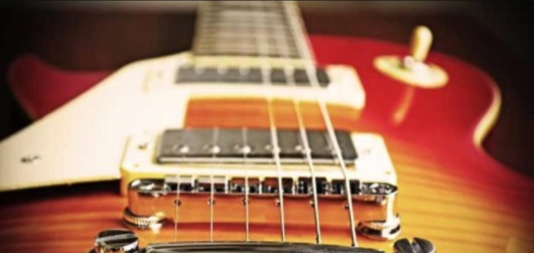 The body and strings of an electric guitar