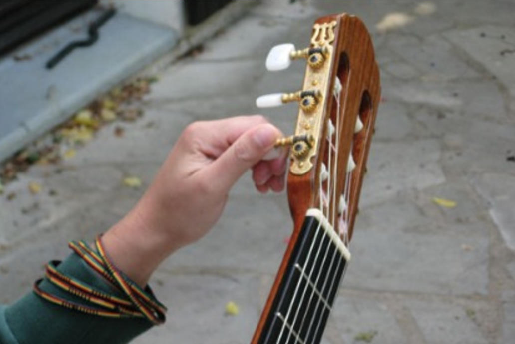 Someone tuning their new classical guitar