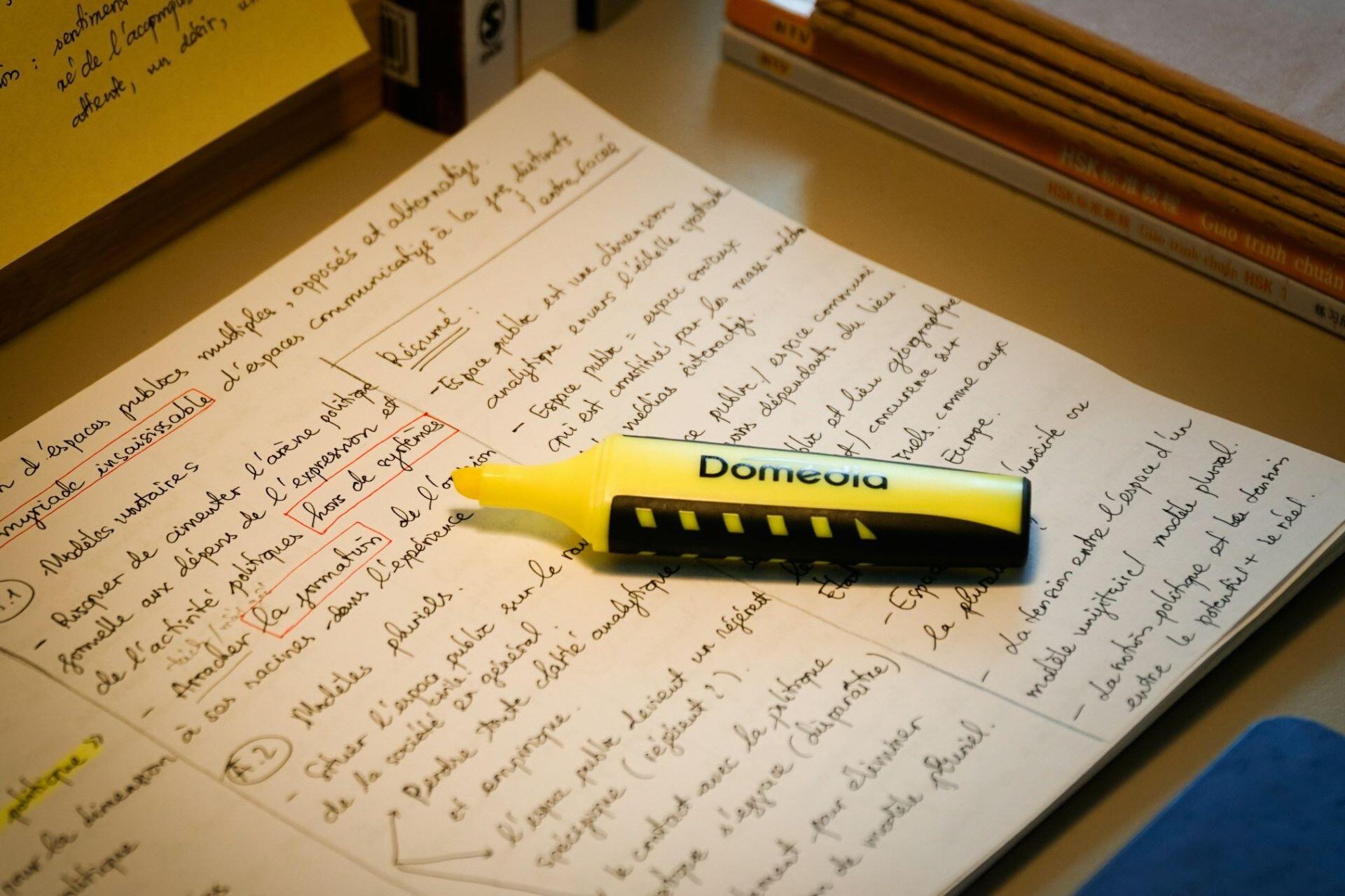Handwritten revision notes with a yellow highlighter