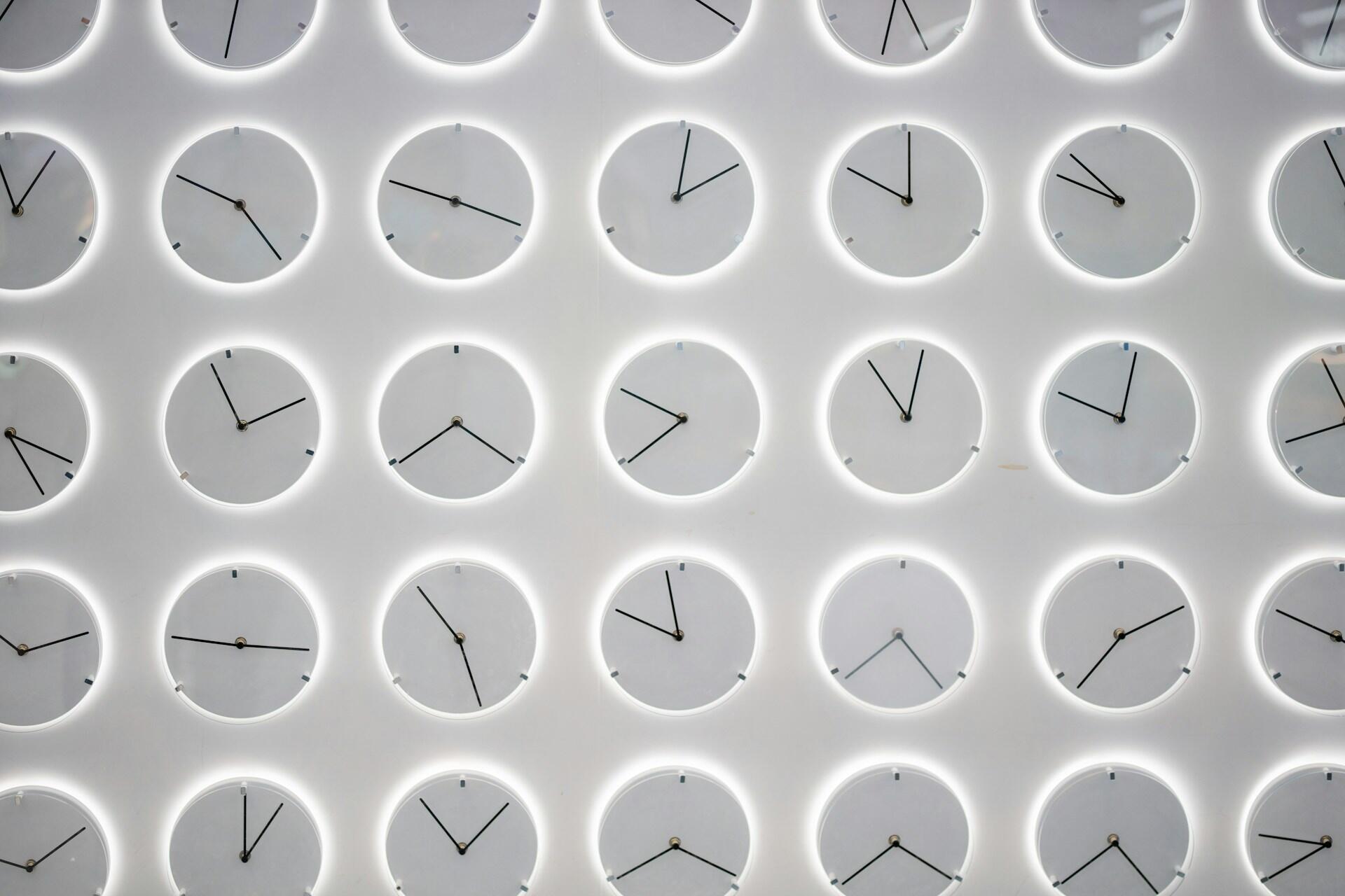 Many clocks on a wall.