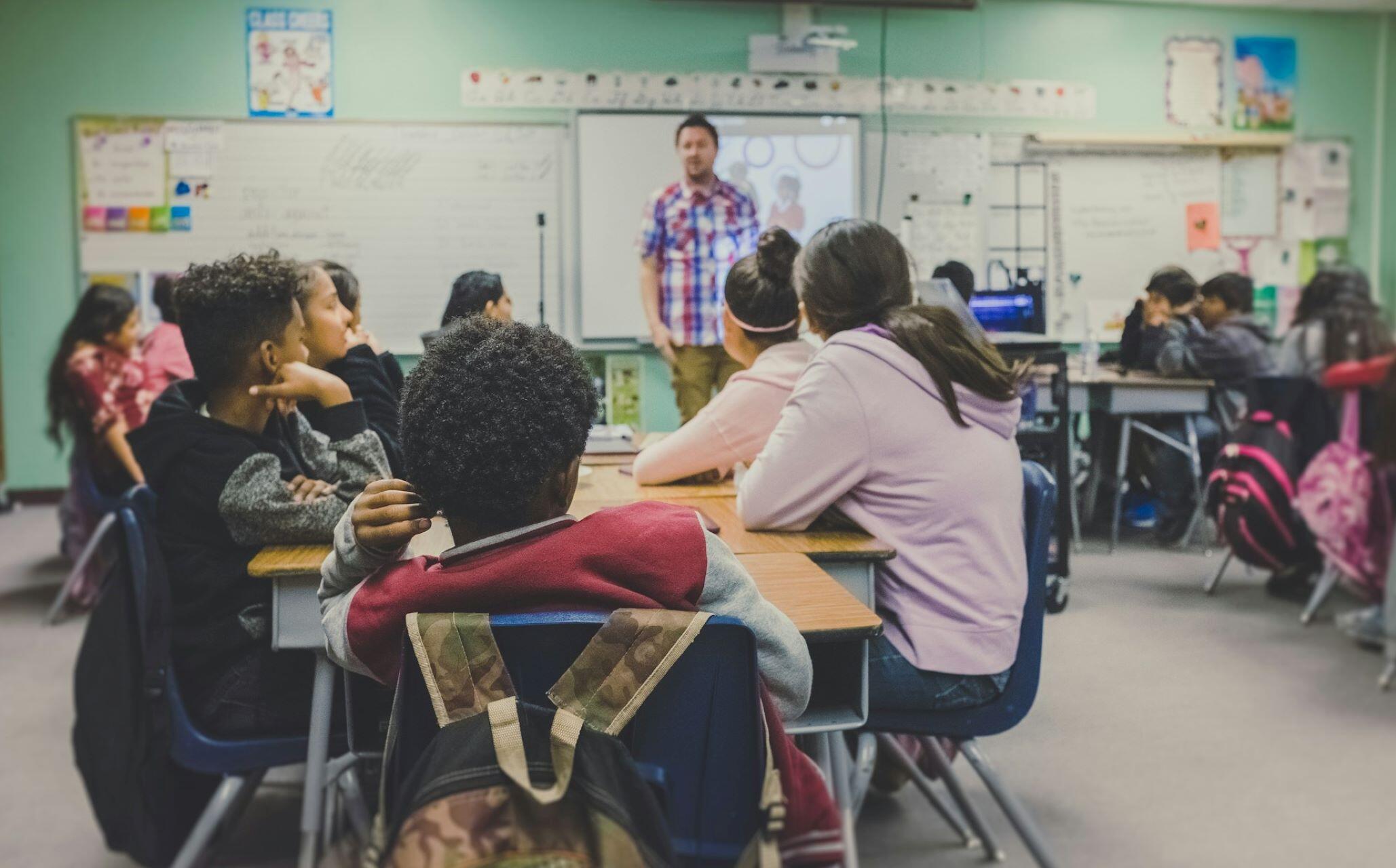 A teacher teaching in a classroom.