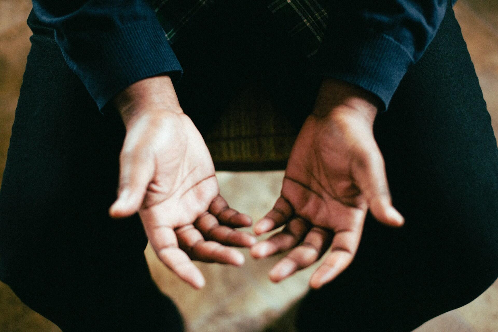 Two open hands held palm-up in soft light