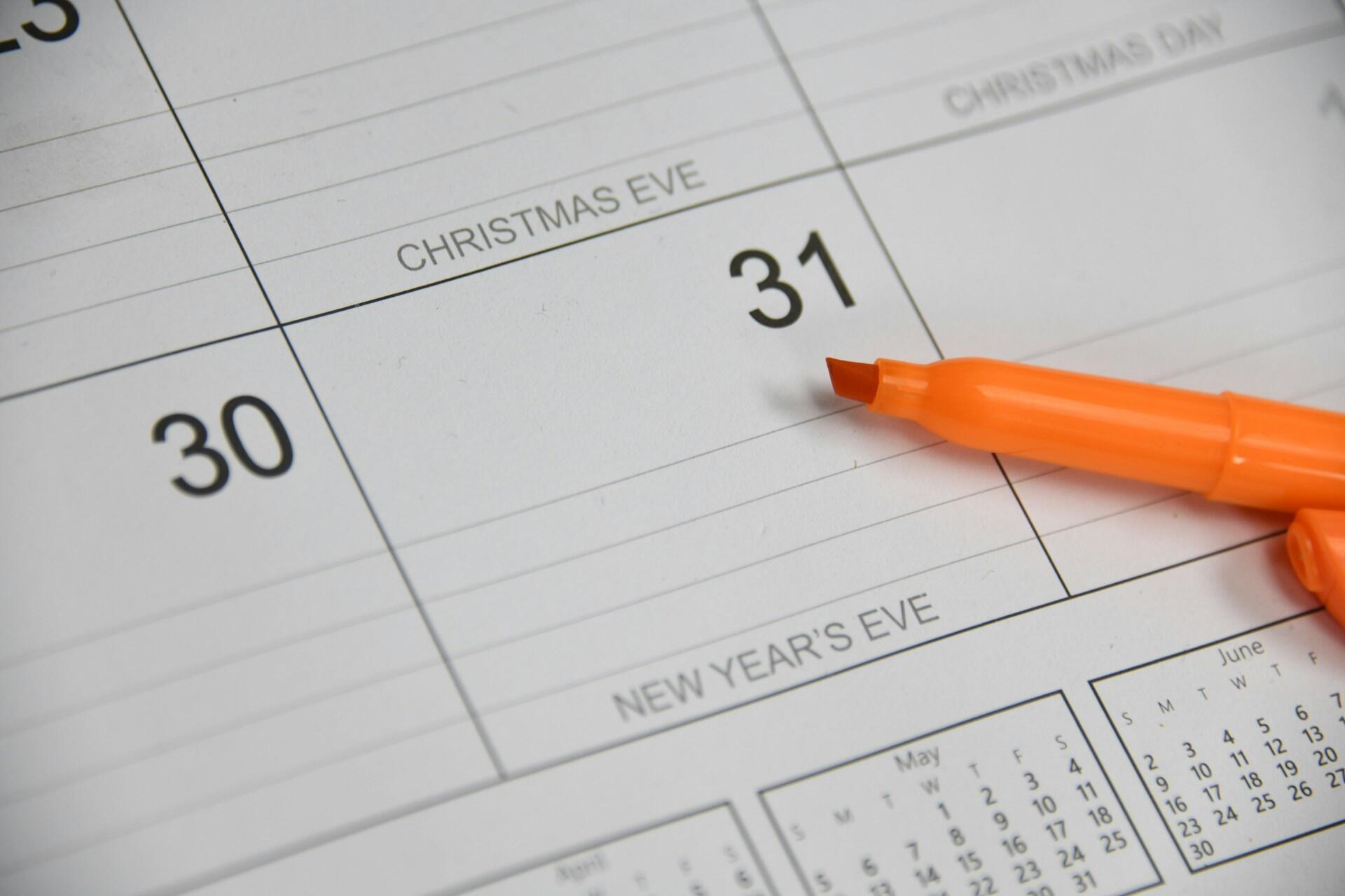 Orange highlighter beside 31 on a paper calendar