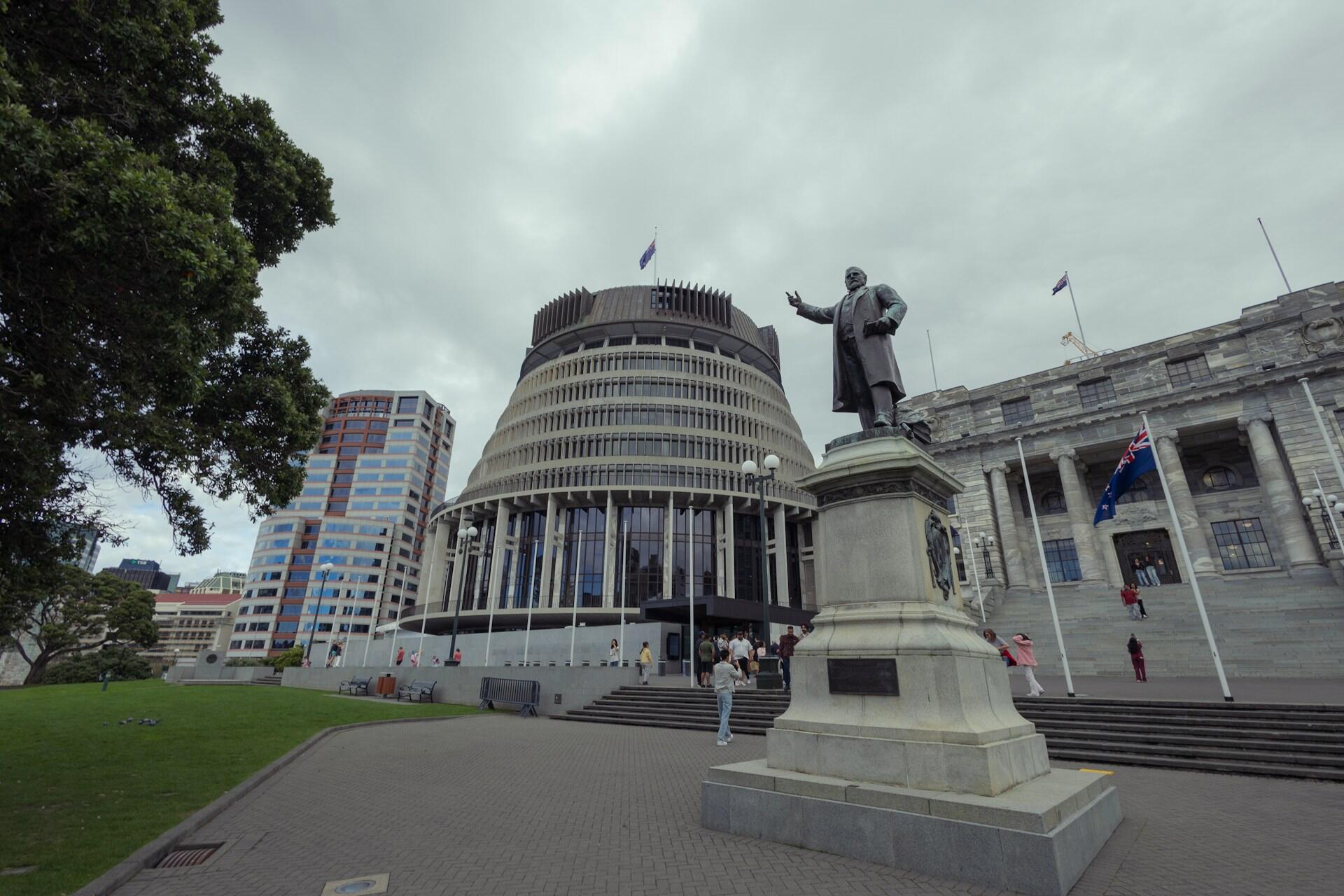 Statue outside the New Zealand Parliament Buildings beneath a cloudy sky