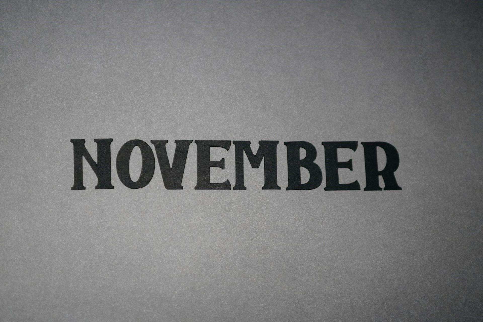 The word November printed in black on grey paper
