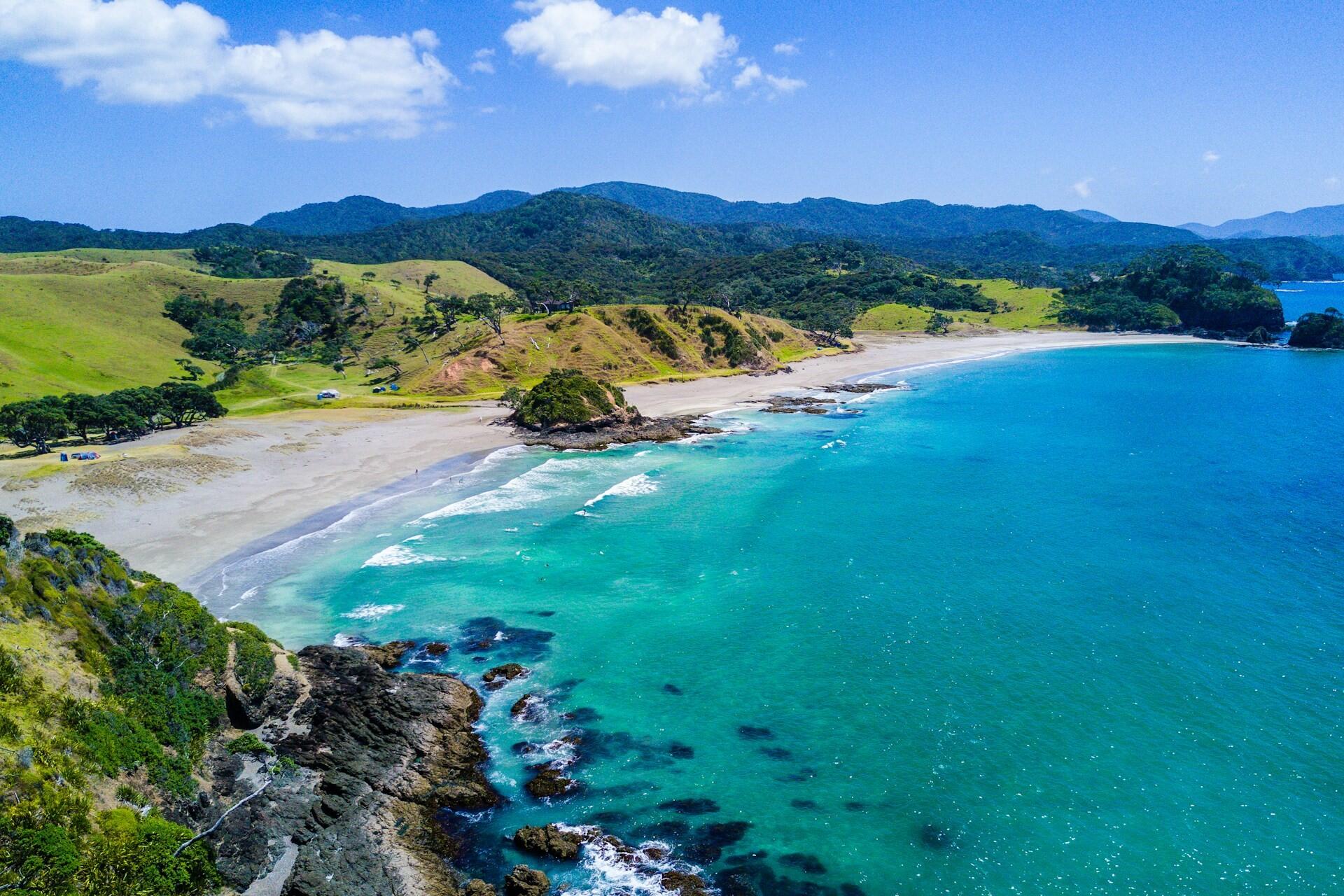 Green coastal hills, sandy beaches and turquoise sea