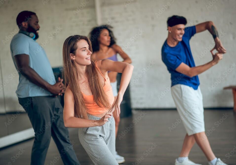 Group of people learning new movements during th dance class