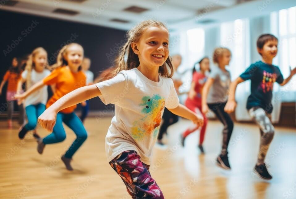 Portrait of smiling children of 7-13 years old enjoying modern dancing in a dance studio