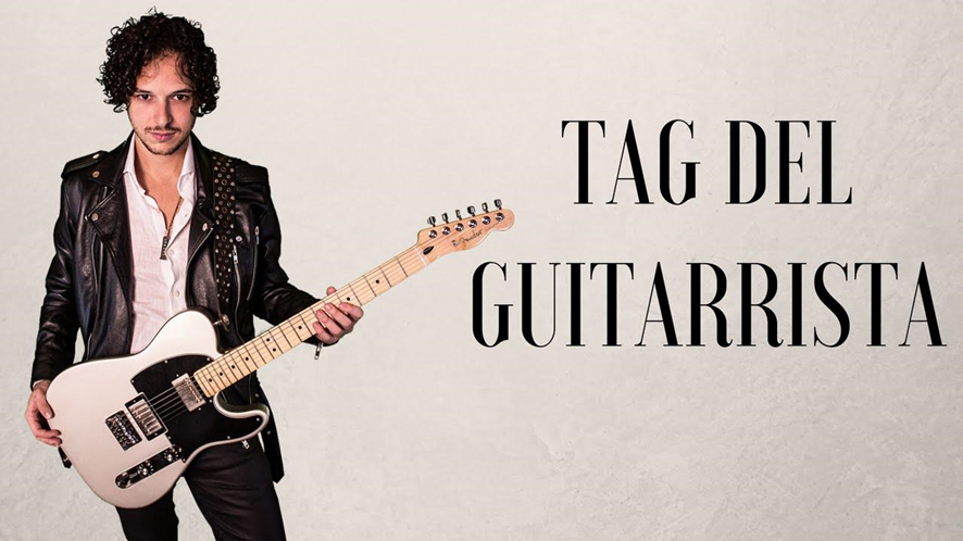 hombre sosteniendo su guitarra y unas letras que dicen tag del guitarrista