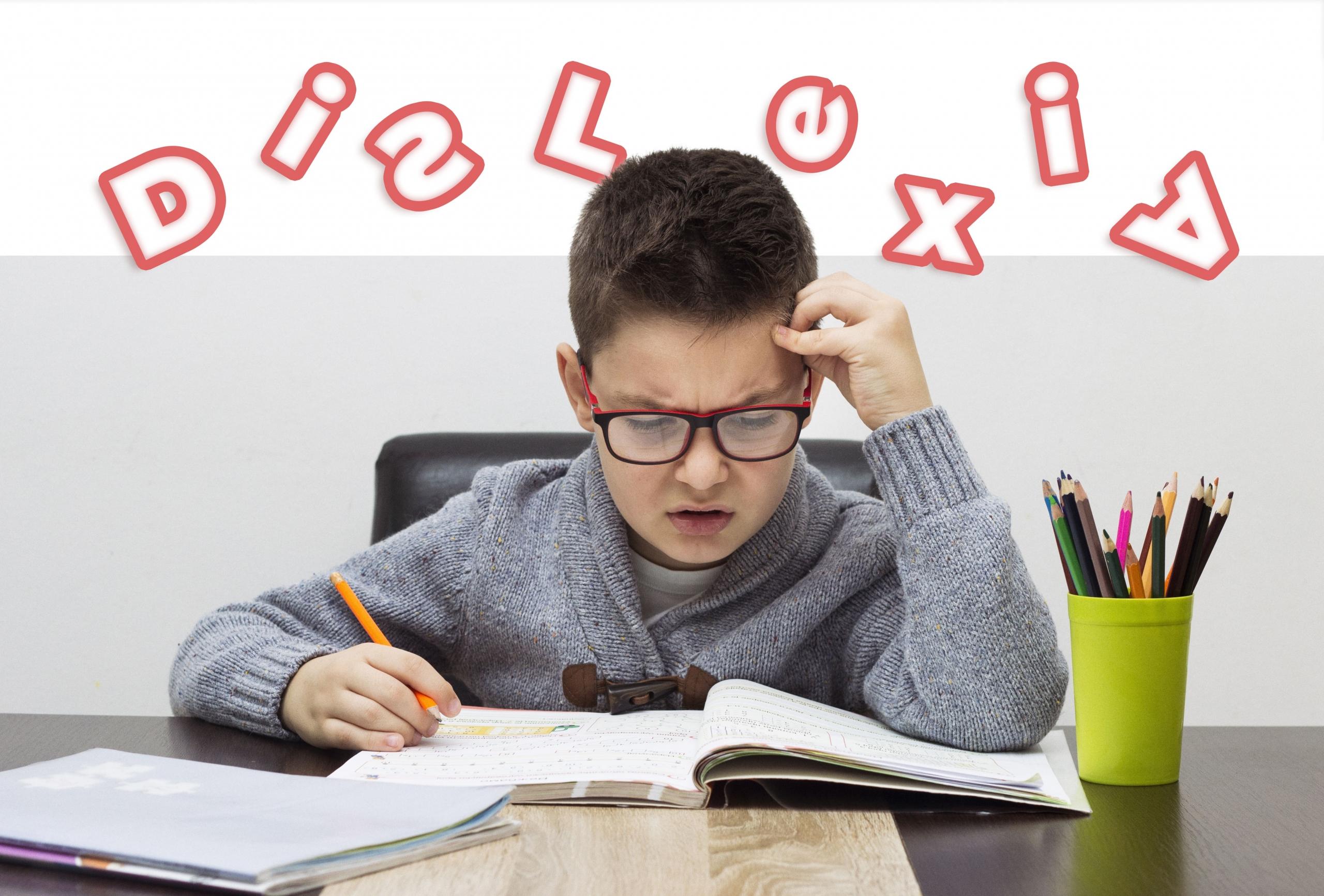 niño mirando sus libros con cara de disgusto y frustración