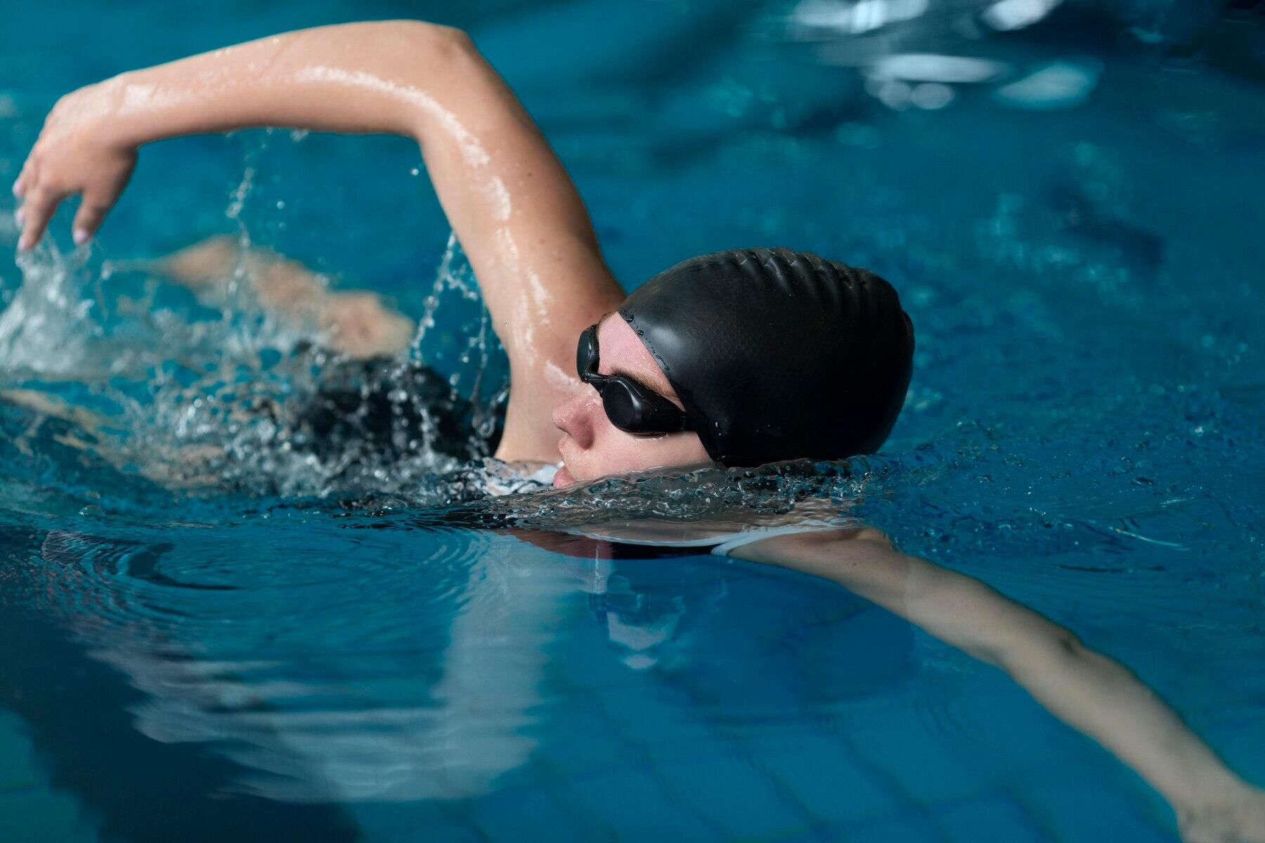 chica haciendo una braceada en la piscina con cabeza fuera del agua