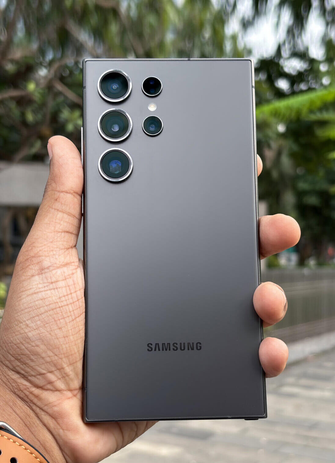 Samsung en mano de una persona con fondo de un parque