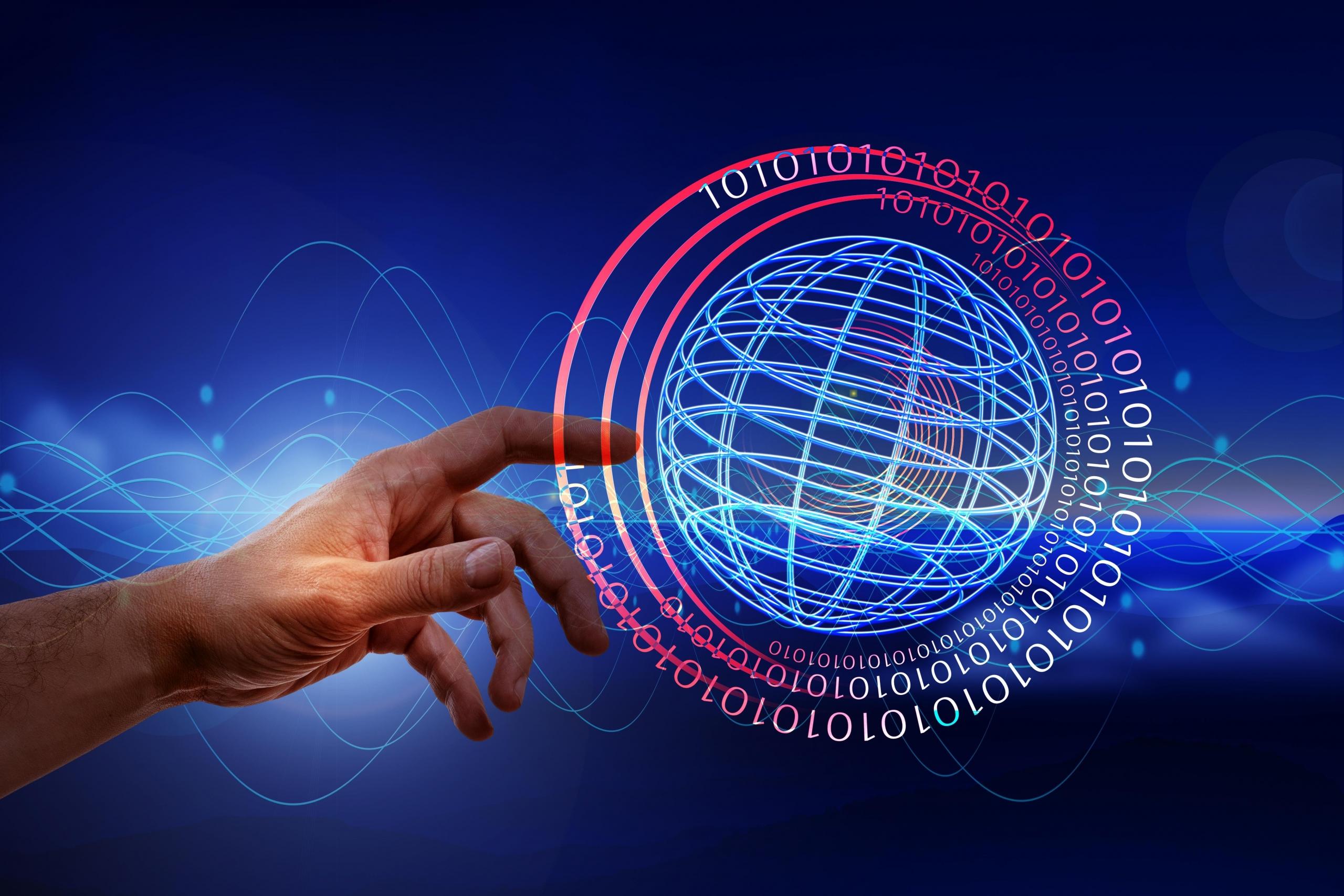 Dłoń dotykająca wirtualnego symbolu świata.