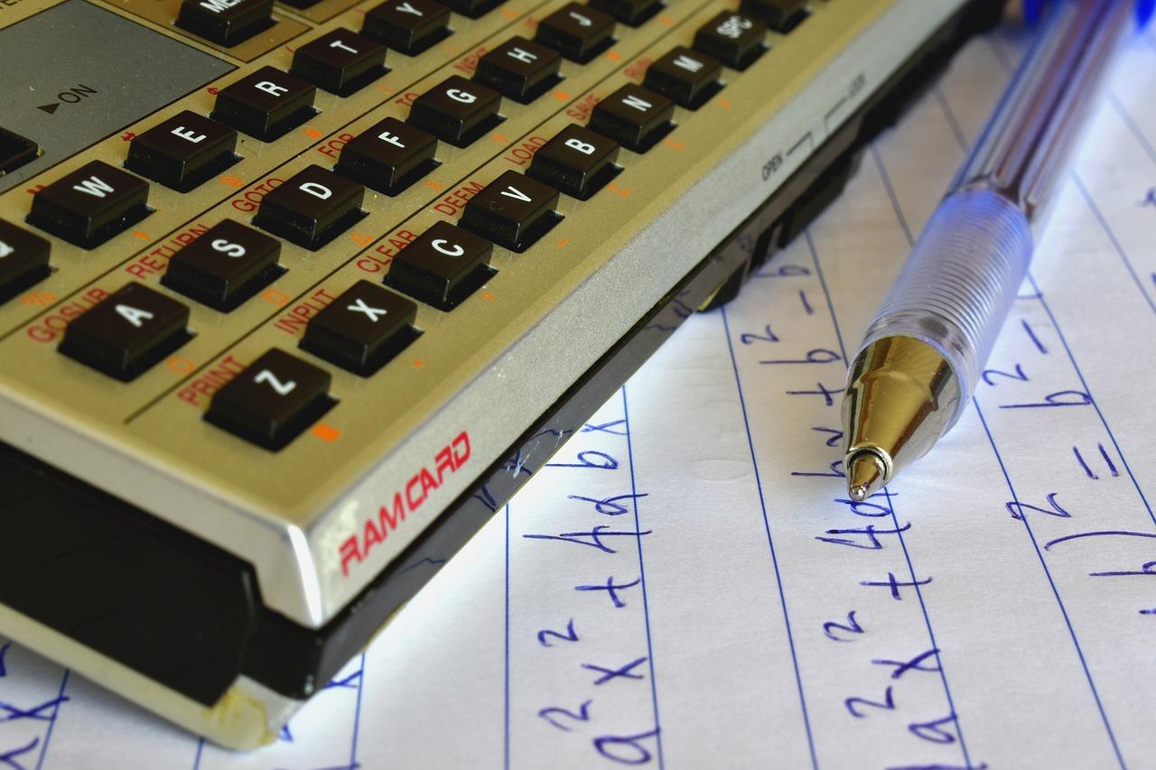 Długopis, zeszyt, kalkulator, matematyka, algebra, równania matematyczne.