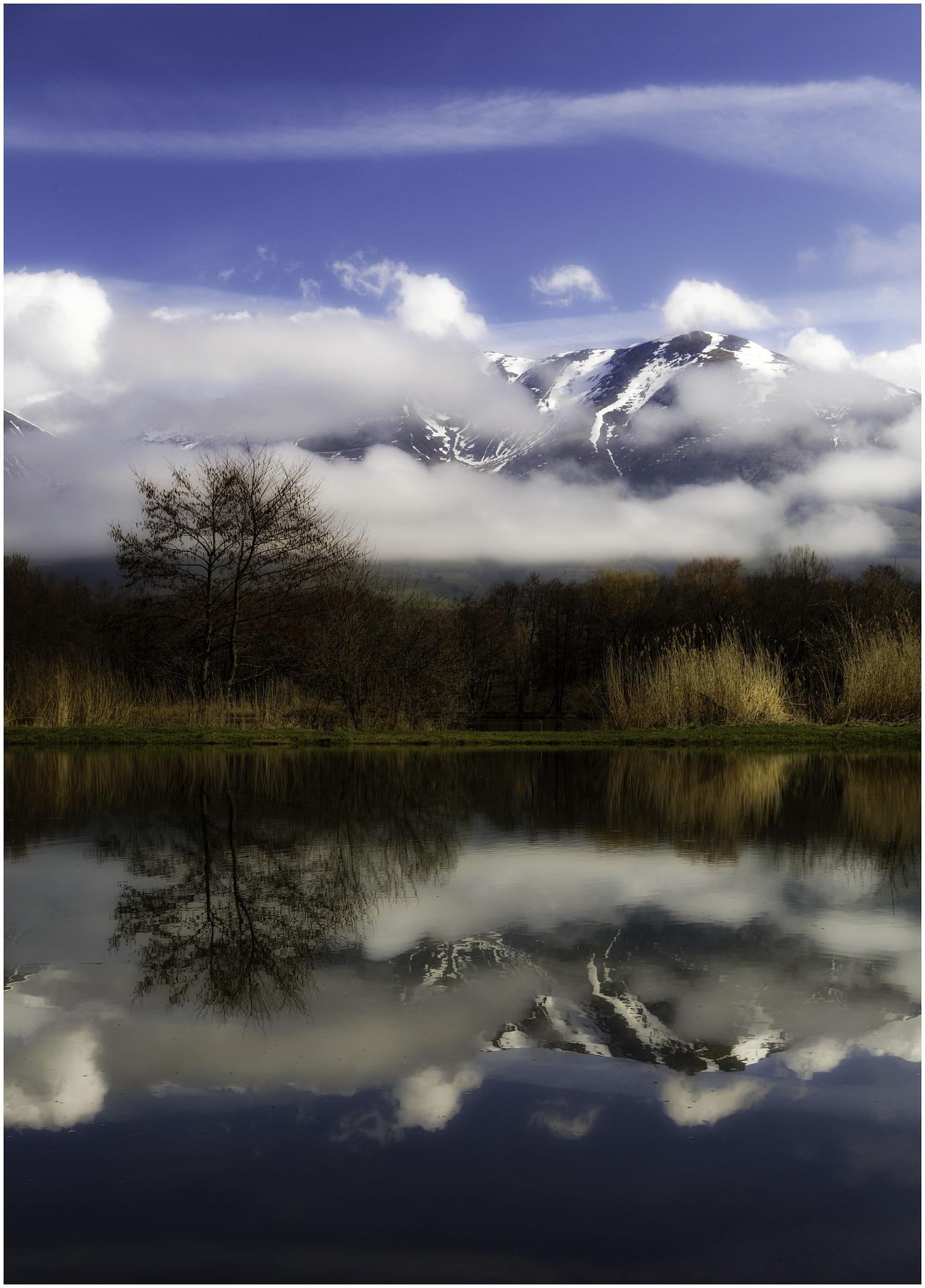 Zaśnieżona góra odbita w tafli jeziora.