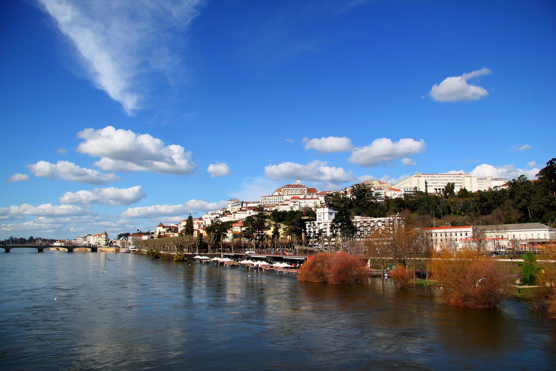 Fotografia da cidade de Coimbra, tirada da margem do Mondego.