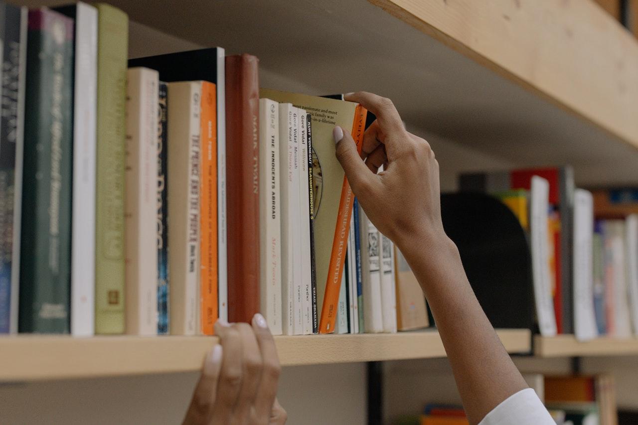 tirar livro da prateleira