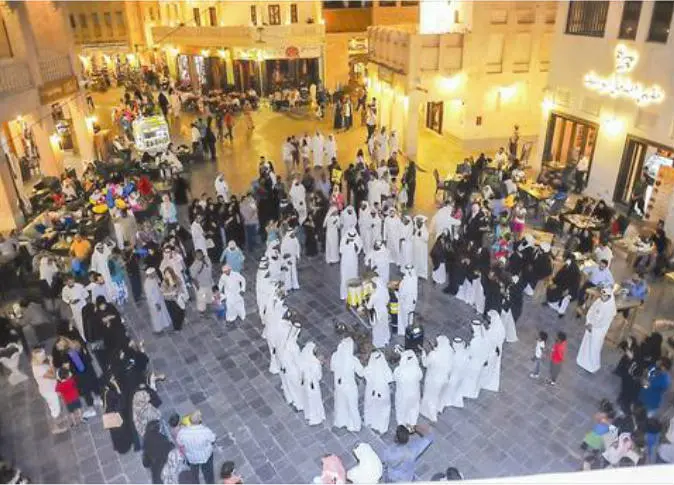 احتفالات عيد الأضحى في سوق واقف بقطر، مع أجواء مبهجة وزينة تقليدية وعائلات تتجول بين المحلات والمقاهي