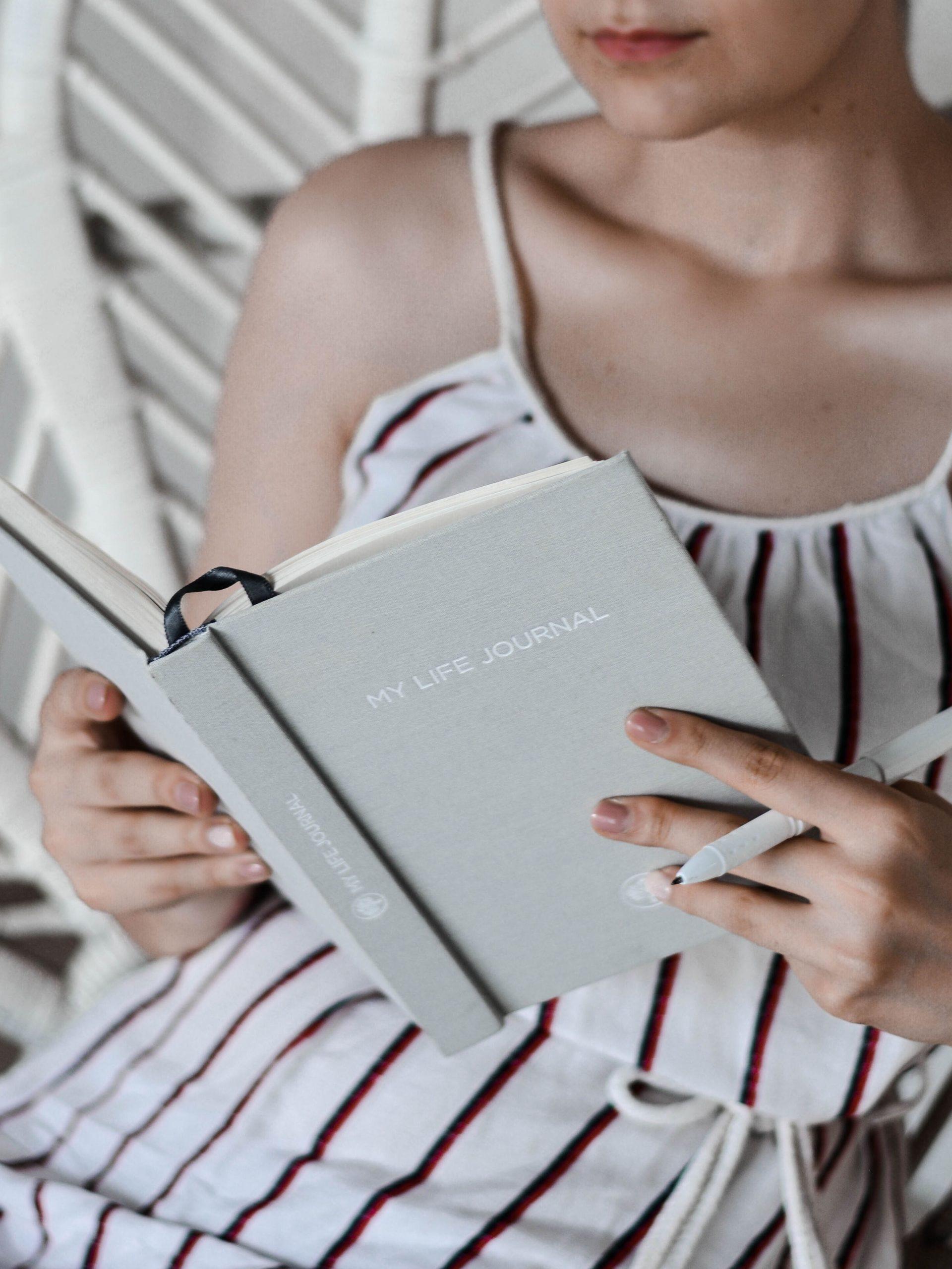 Une jeune femme lit son agenda;