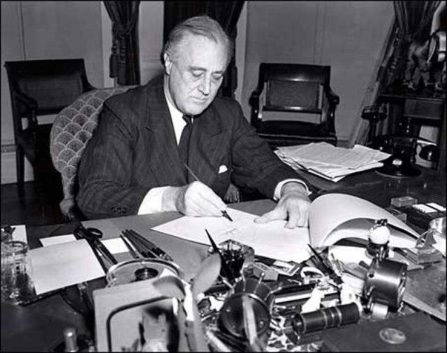 President Franklin D. Roosevelt signing the Lend-lease act