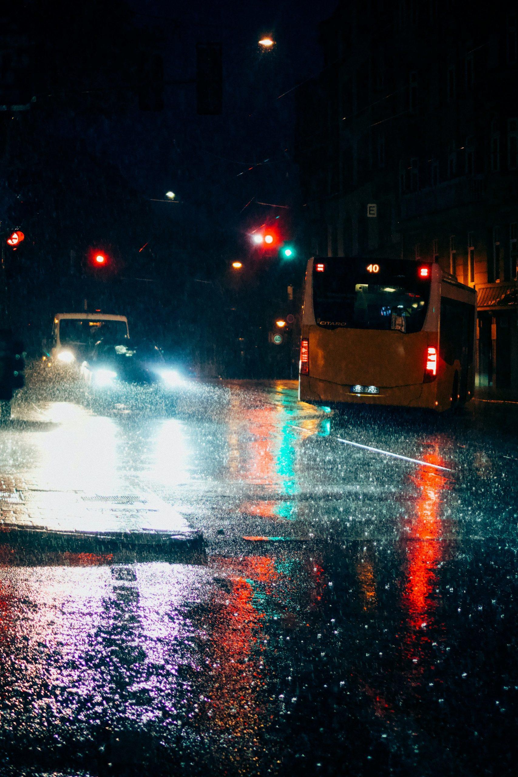 buses on the road and heavy rain in the city