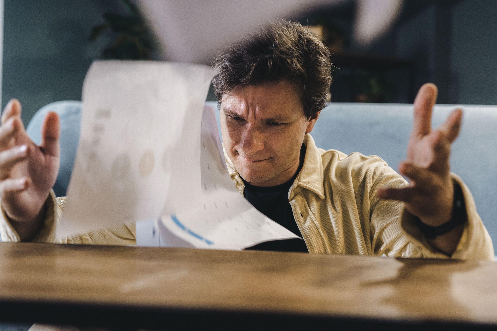 Man throwing up pages in anger
