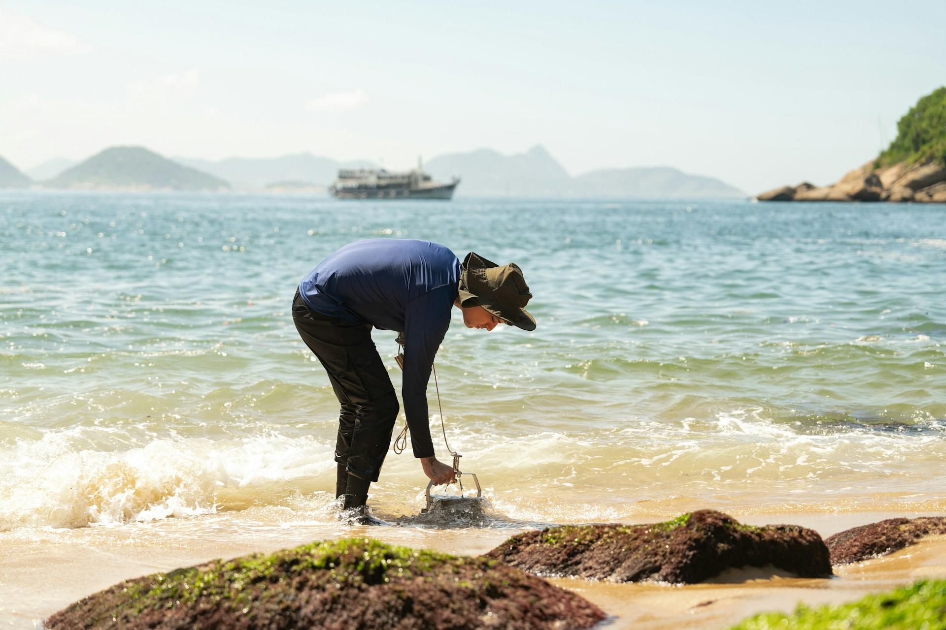 person cleaning up the beach