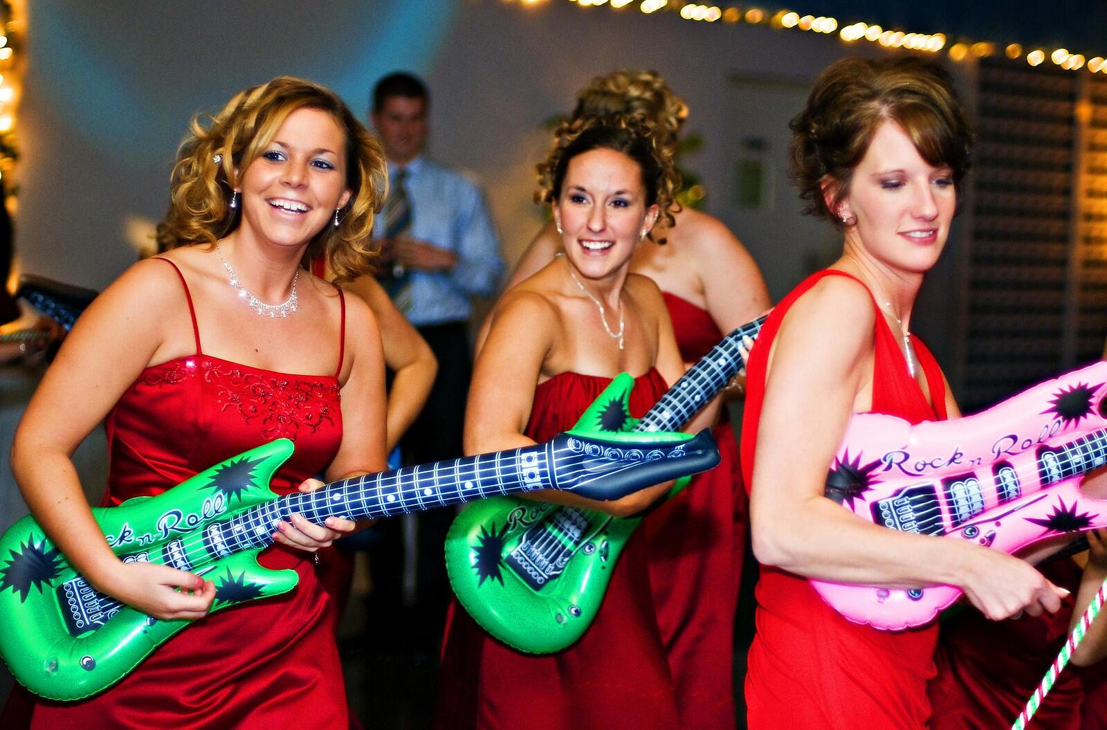 A group of women with a deflectable toy guitar.