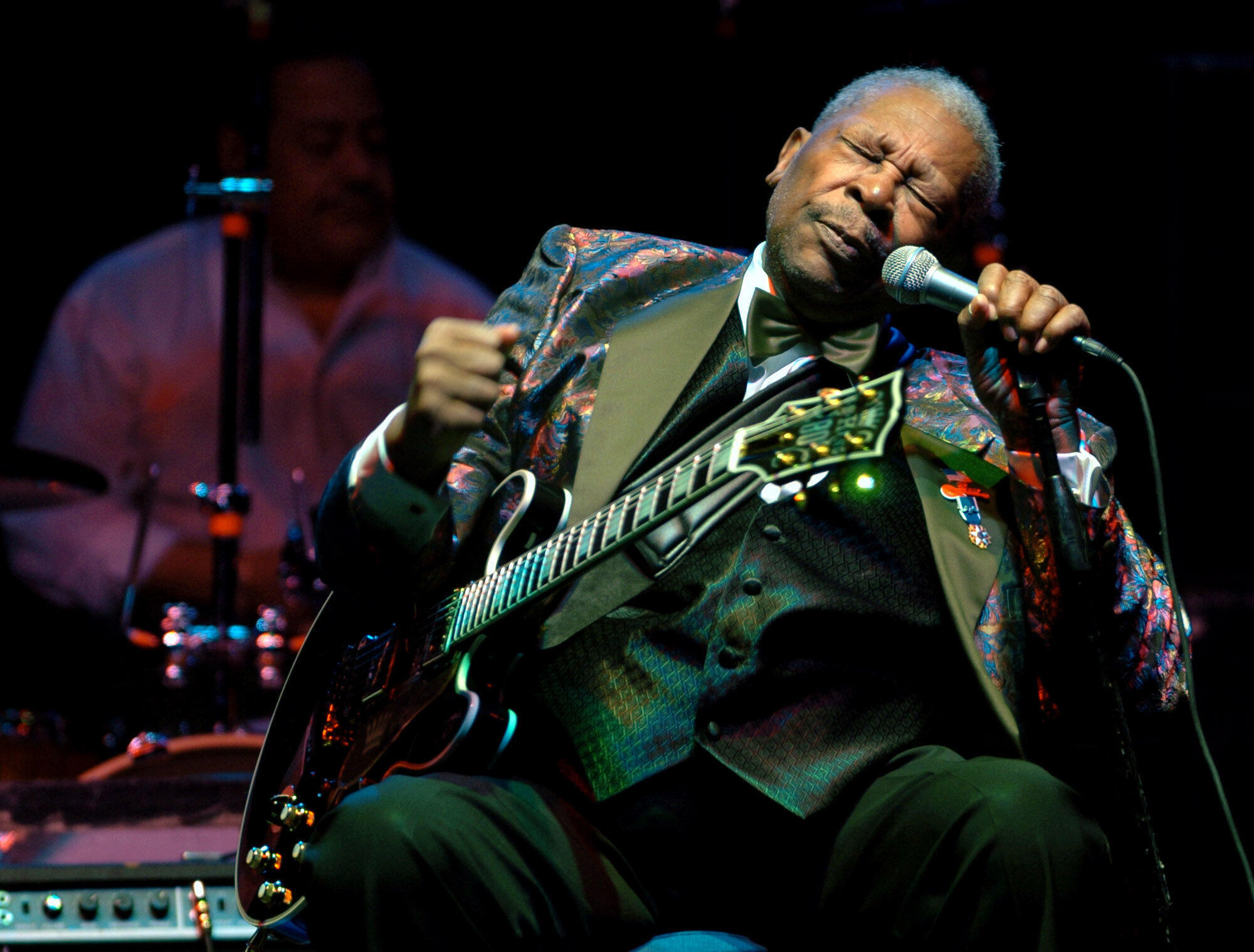 A picture of BB King performing on stage. 